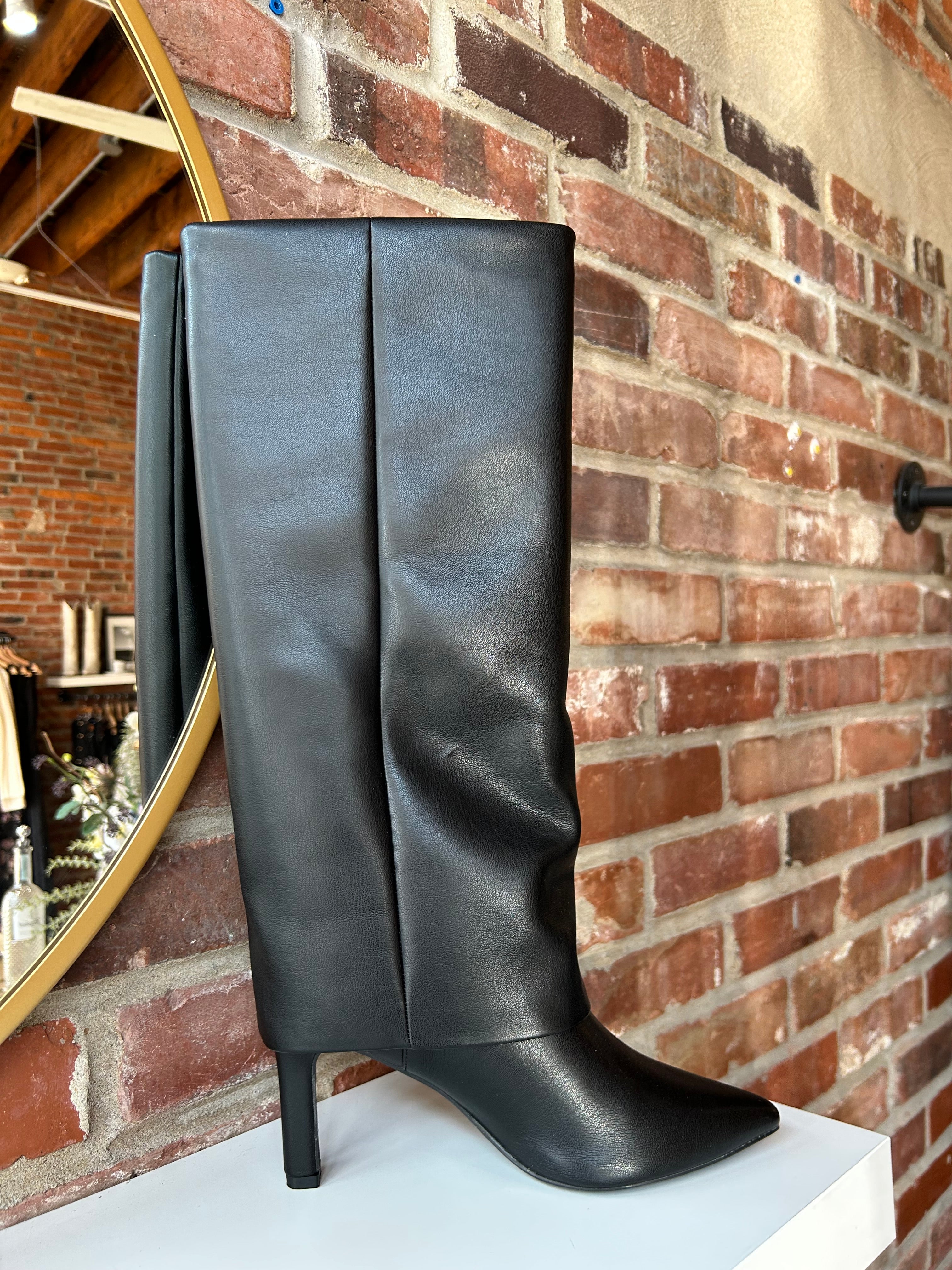 Black leather fold over knee boot with pointed toed and 3 1/4 inch heel.