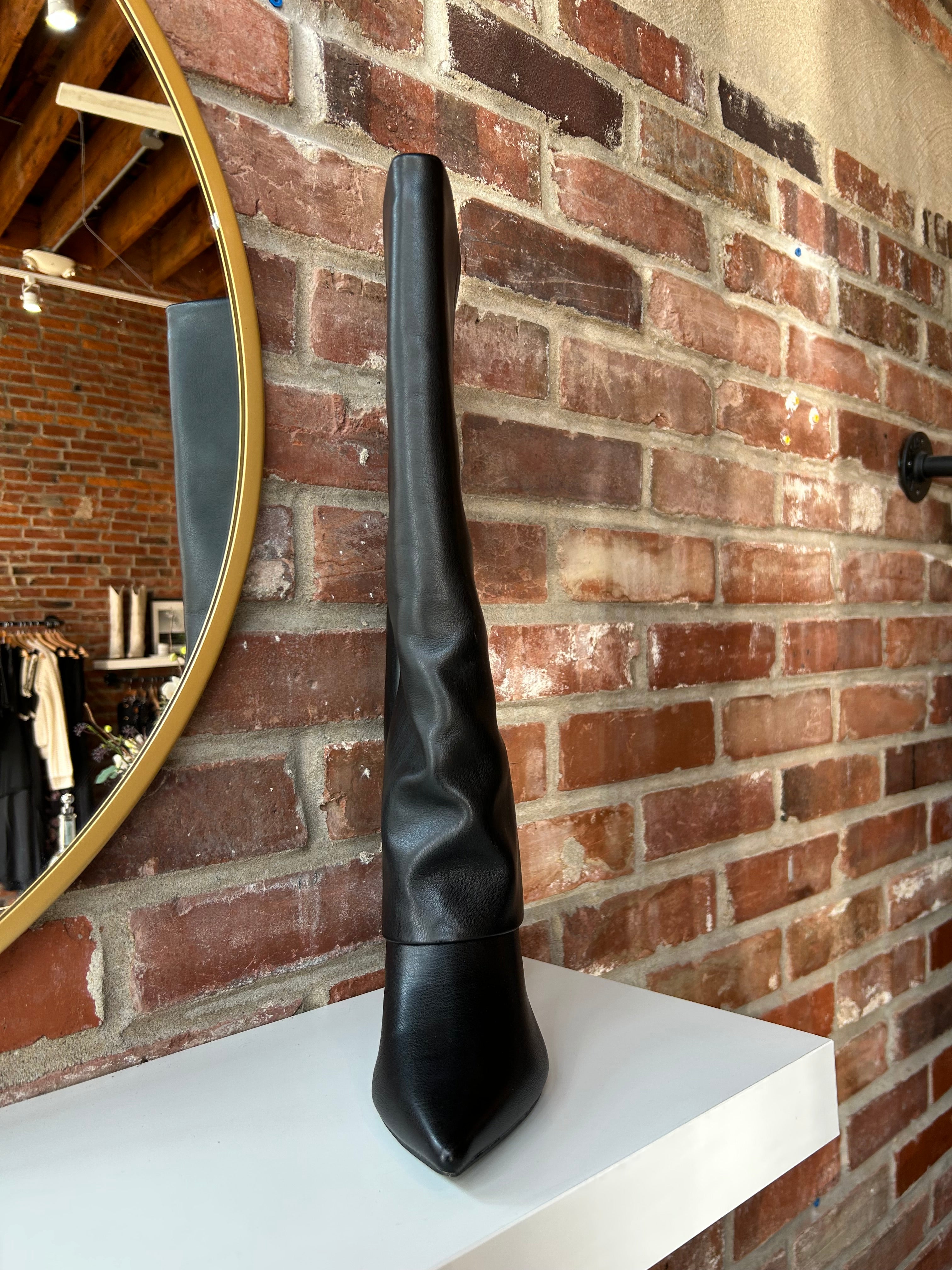 Black leather fold over knee boot with pointed toed and 3 1/4 inch heel.