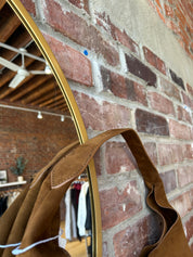 Camel suede shoulder bag with magnetic closure.