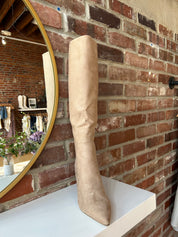 Tan suede knee-high boots with gold zipper hardware.