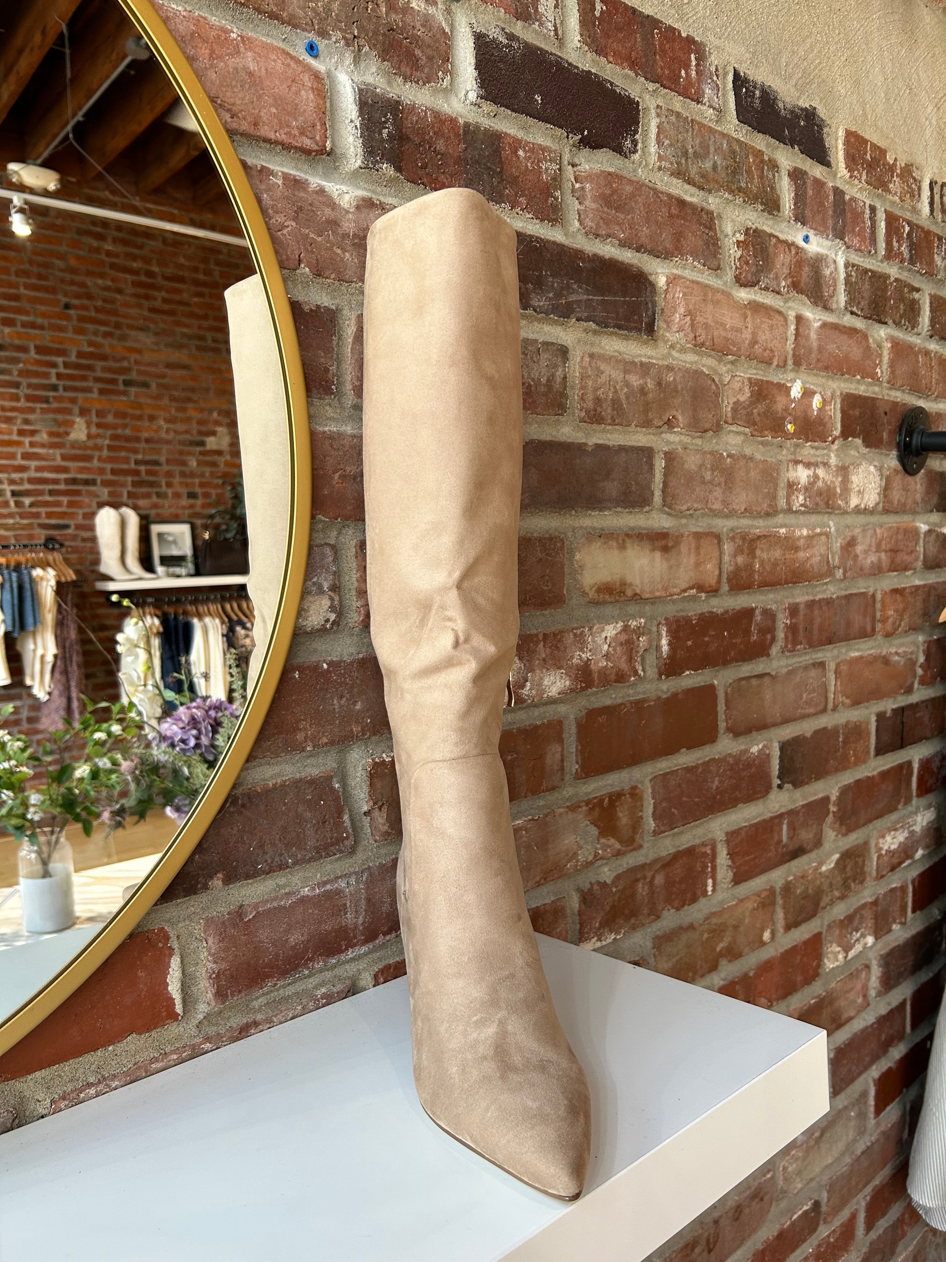 Tan suede knee-high boots with gold zipper hardware.