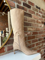 Tan suede knee-high boots with gold zipper hardware.