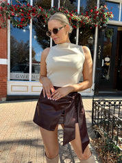 Woman wearing burgundy leather mini wrap skort.