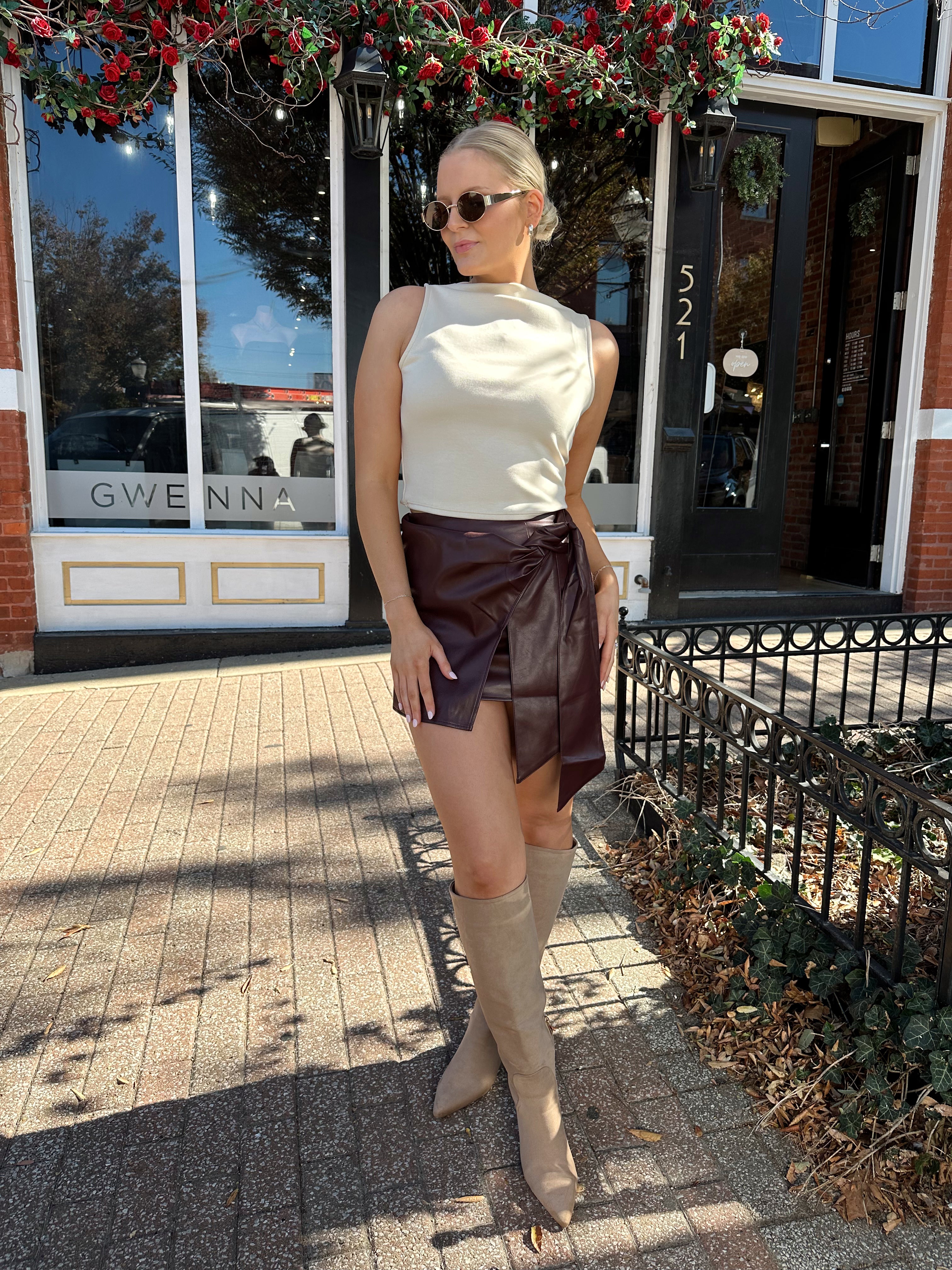 Woman wearing burgundy leather mini wrap skort.