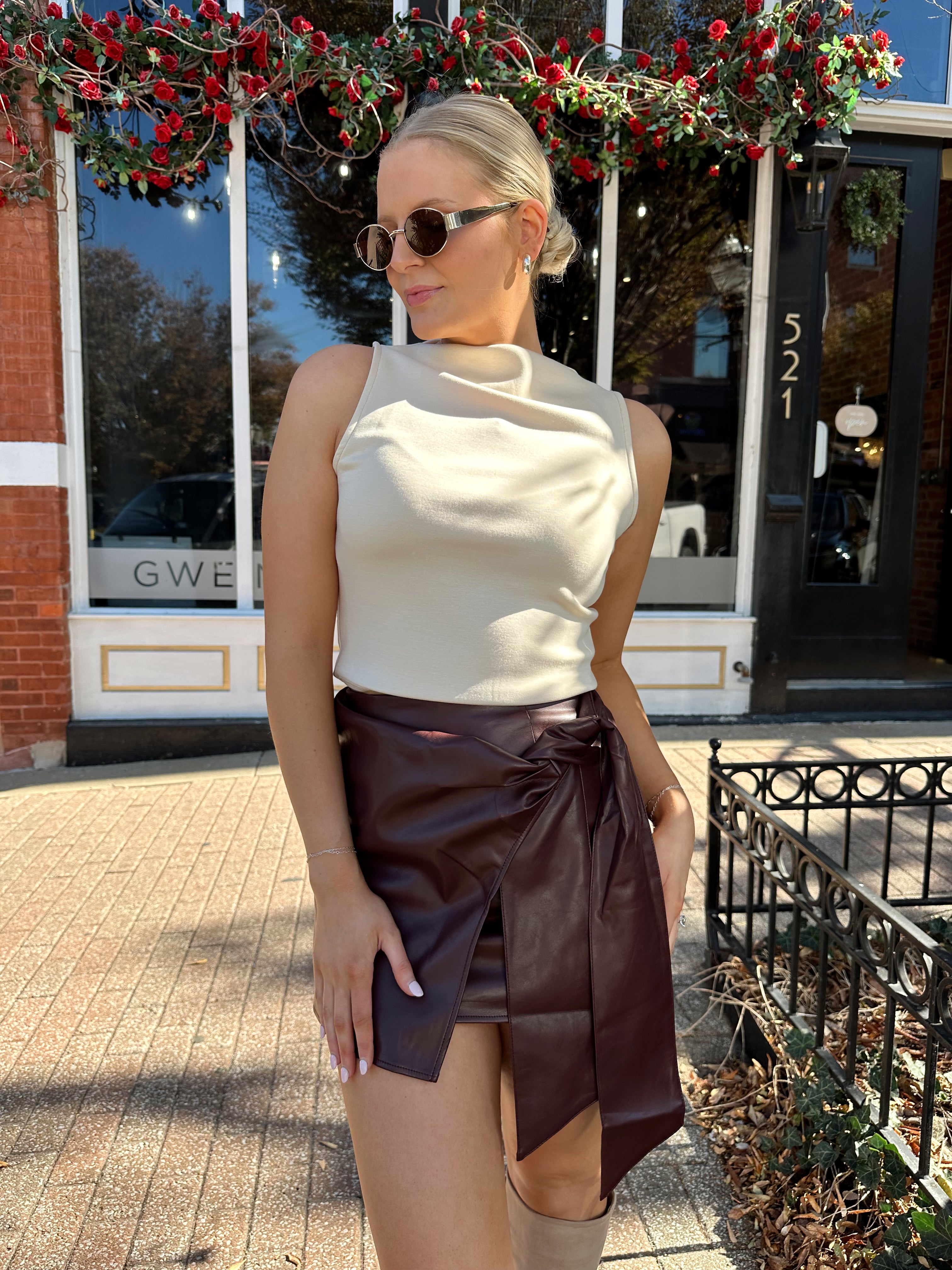 Woman wearing burgundy leather mini wrap skort.