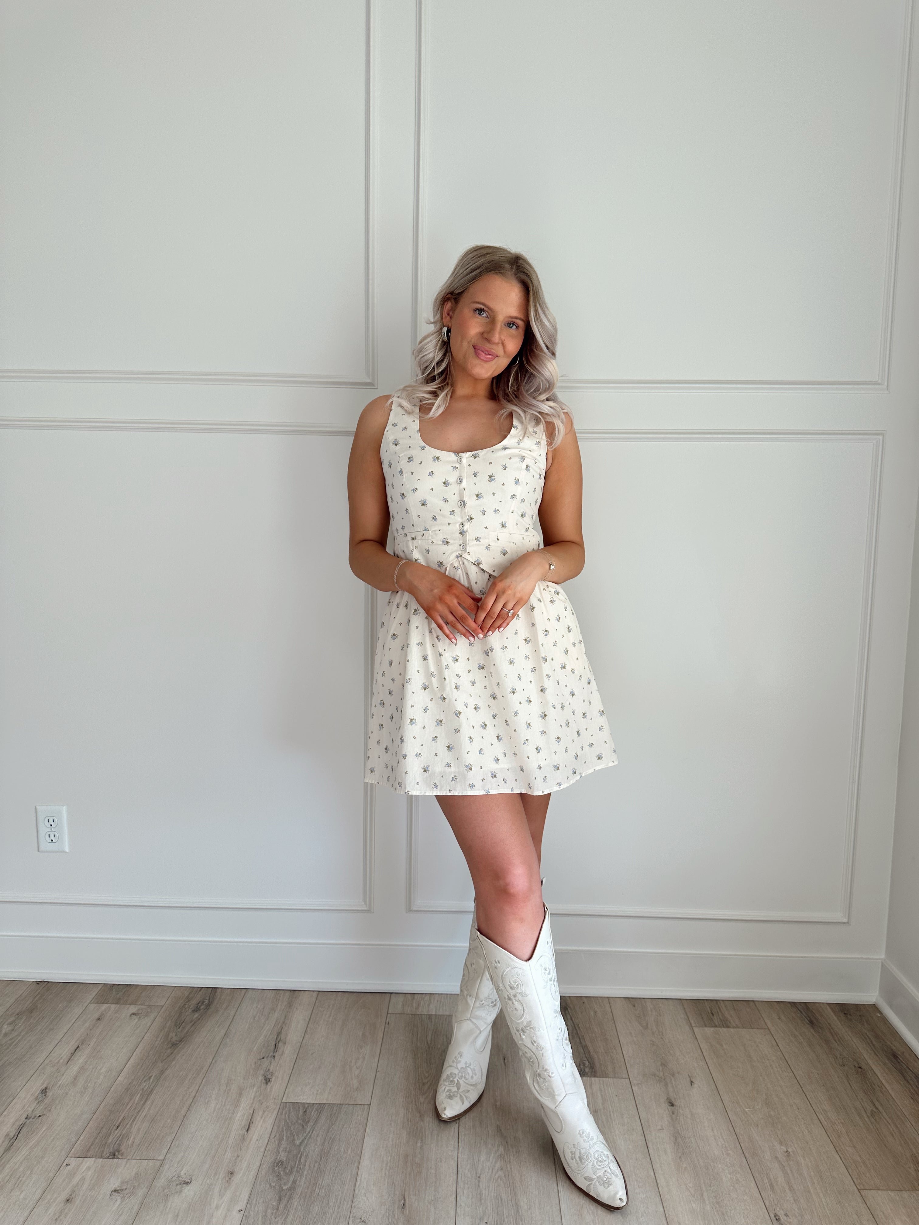 Floral babydoll mini dress with a button-up front and fitted waist.