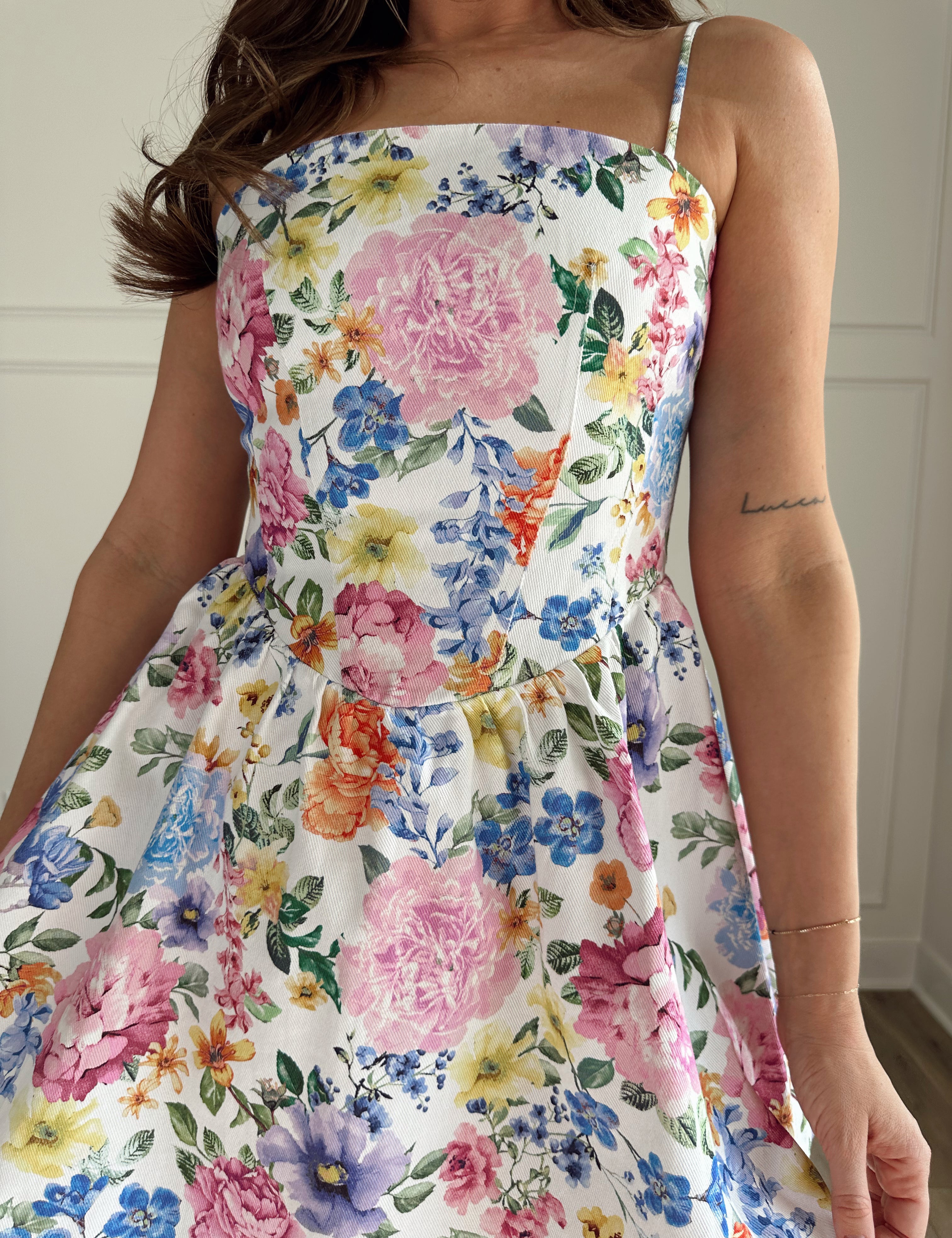 Multi colored floral denim dress with adjustable spaghetti straps.
