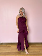 Burgundy formal maxi dress with ruffle detailing and slit up the front. 