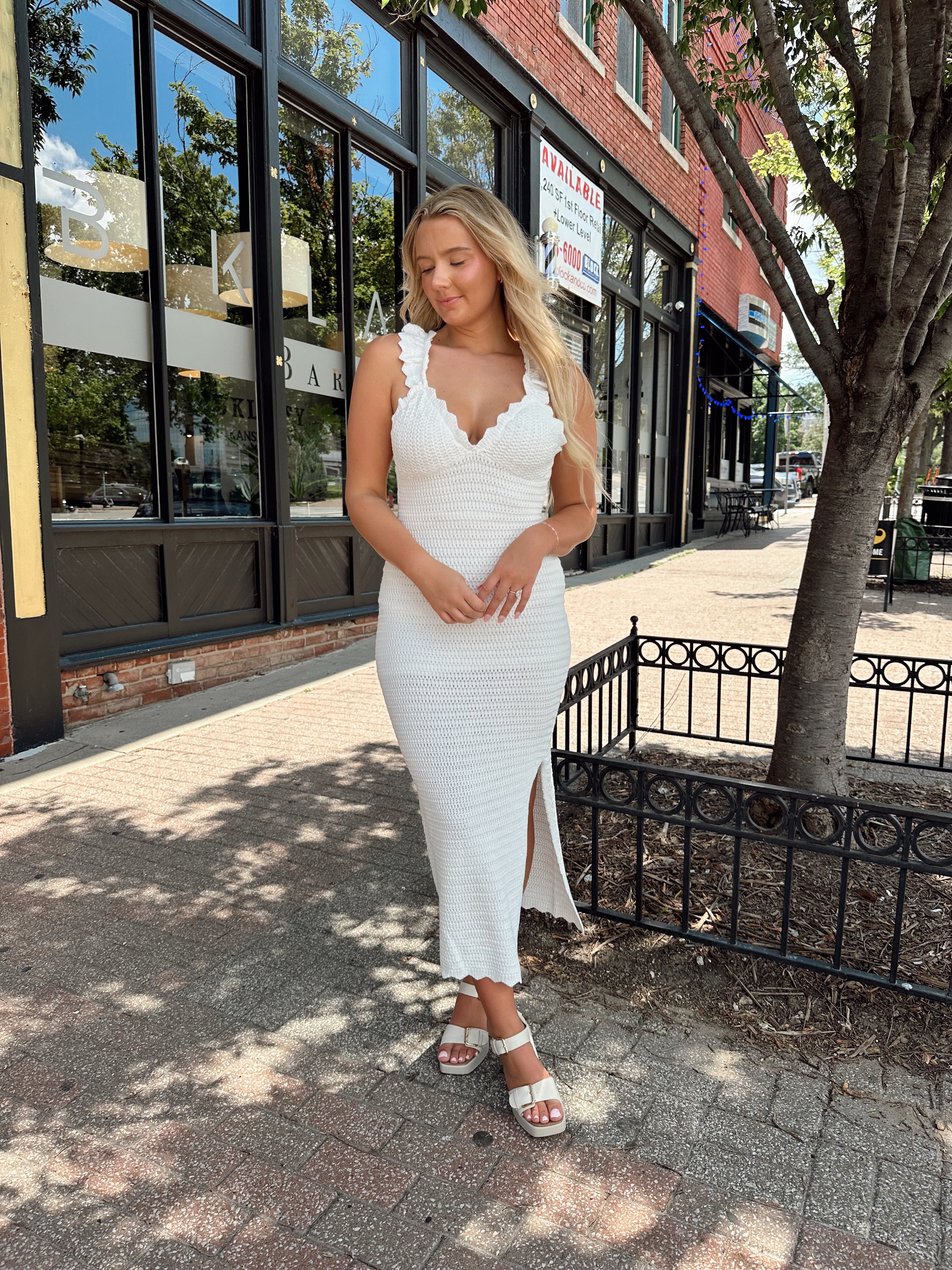 White crochet knit midi dress with open back and ruffle straps.
