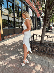 White crochet knit midi dress with open back and ruffle straps.