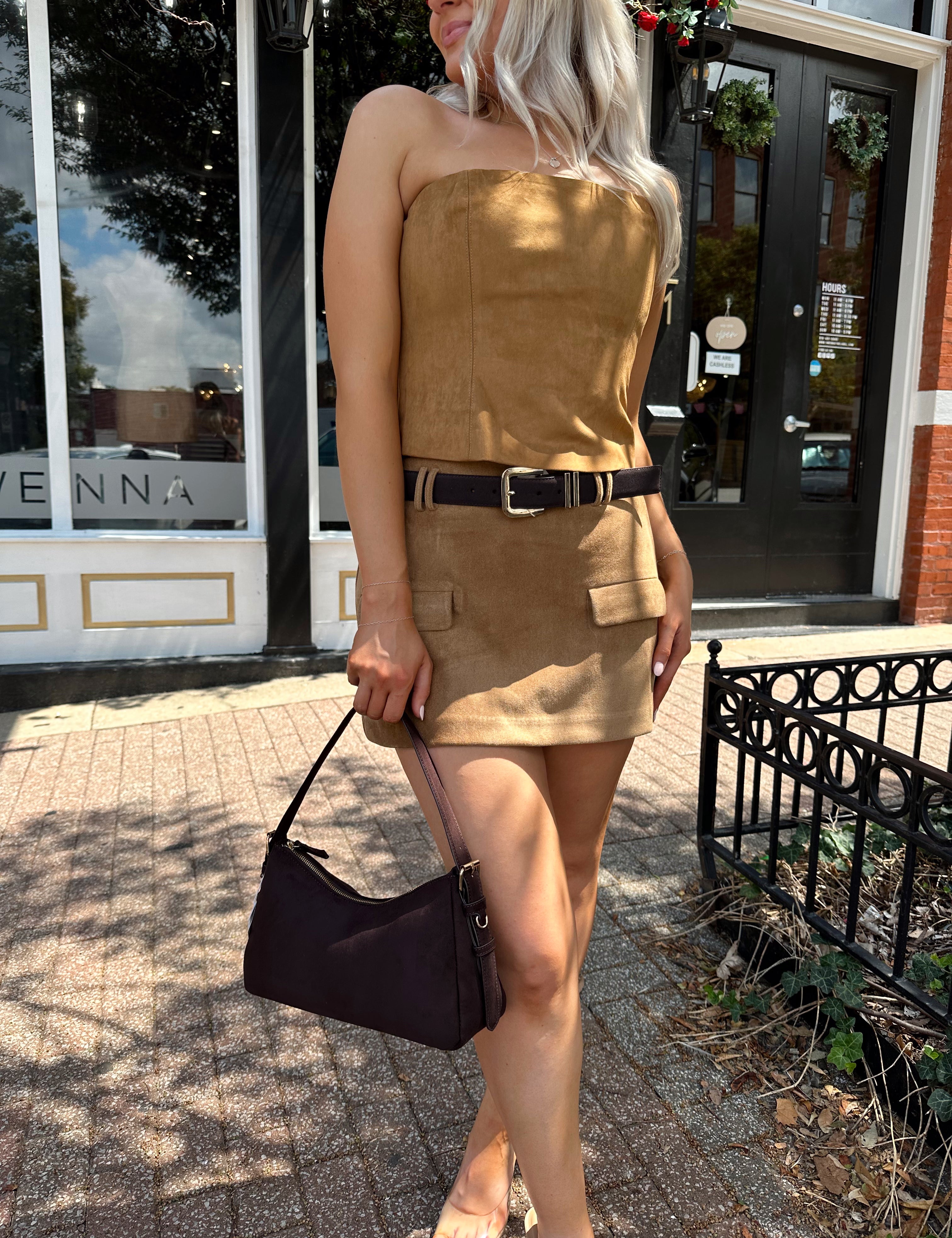 Woman wearing tan suede strapless corset top with suede mini skirt.