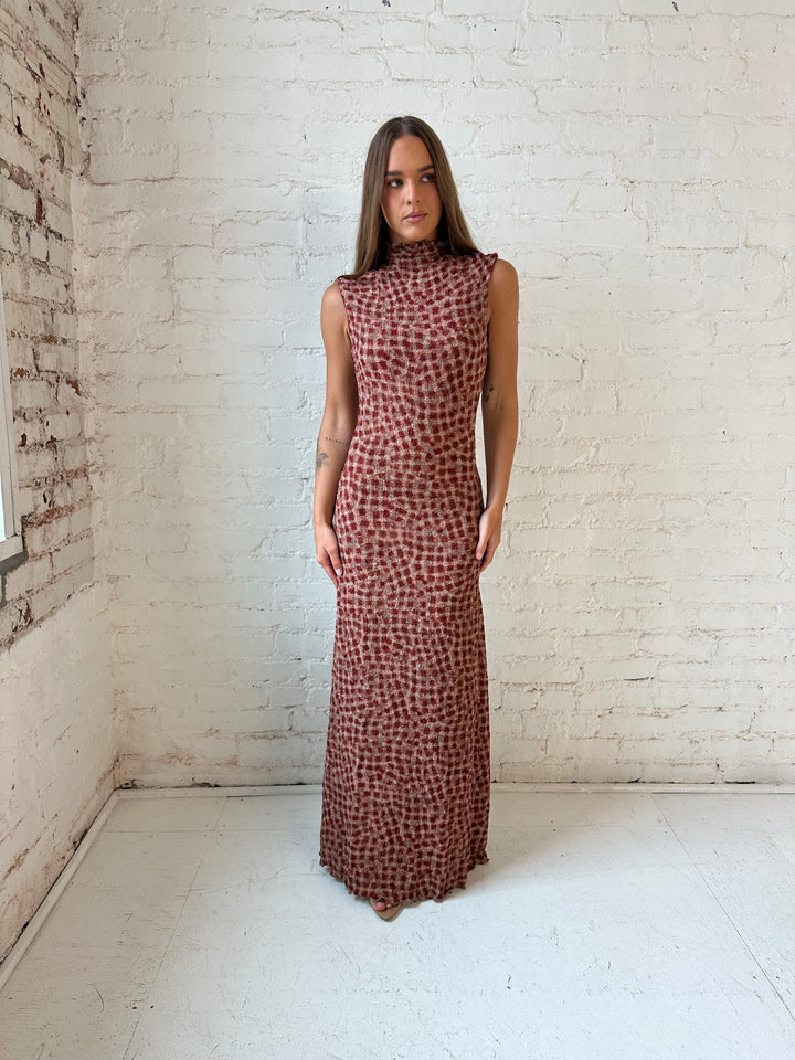 Woman wearing burgundy and brown textured dotted maxi dress.