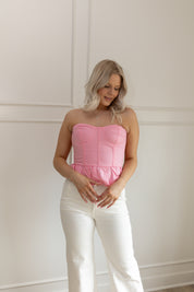 Pink strapless corset peplum top. Smocked back with hidden zipper. 