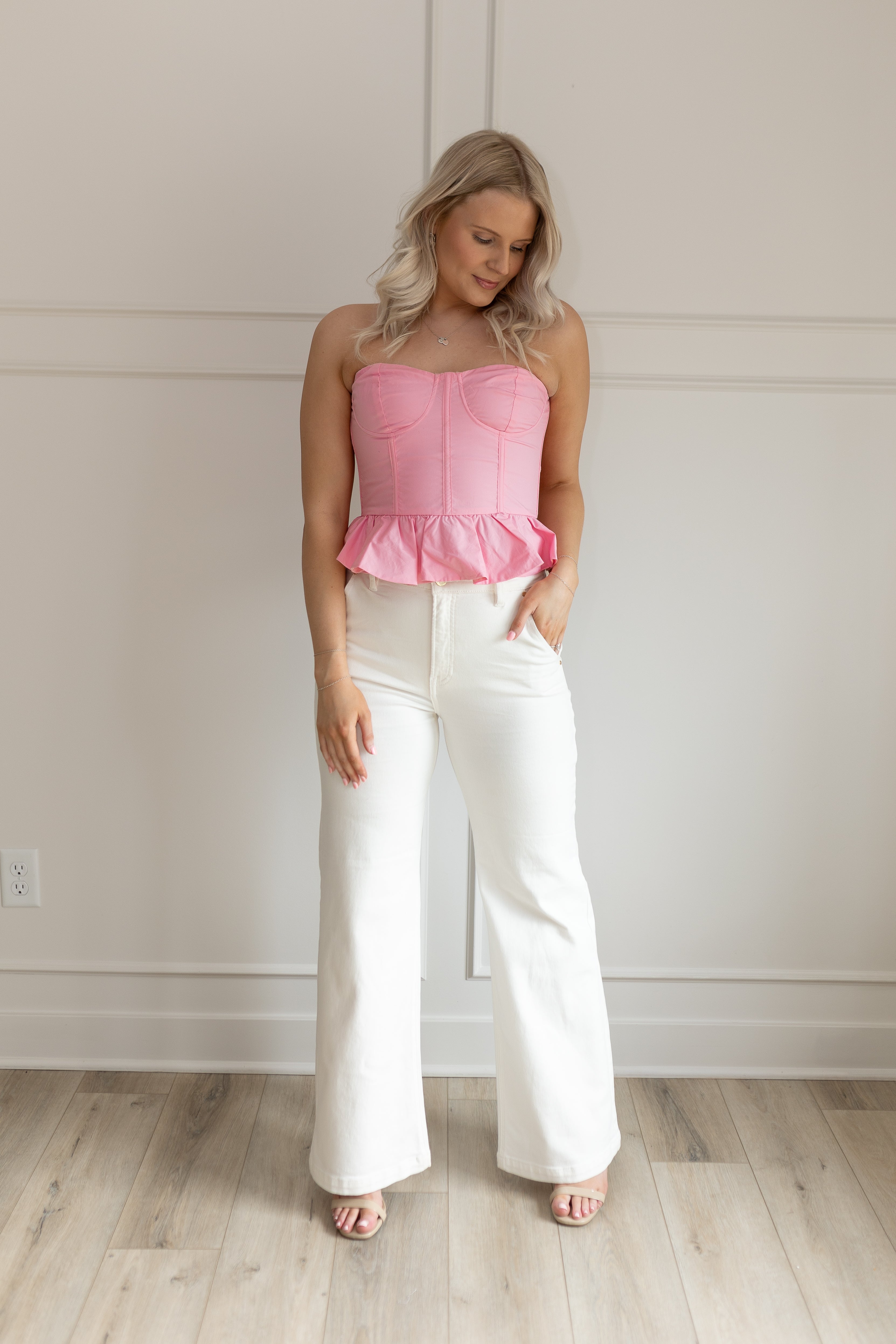 Pink strapless corset peplum top. Smocked back with hidden zipper. 
