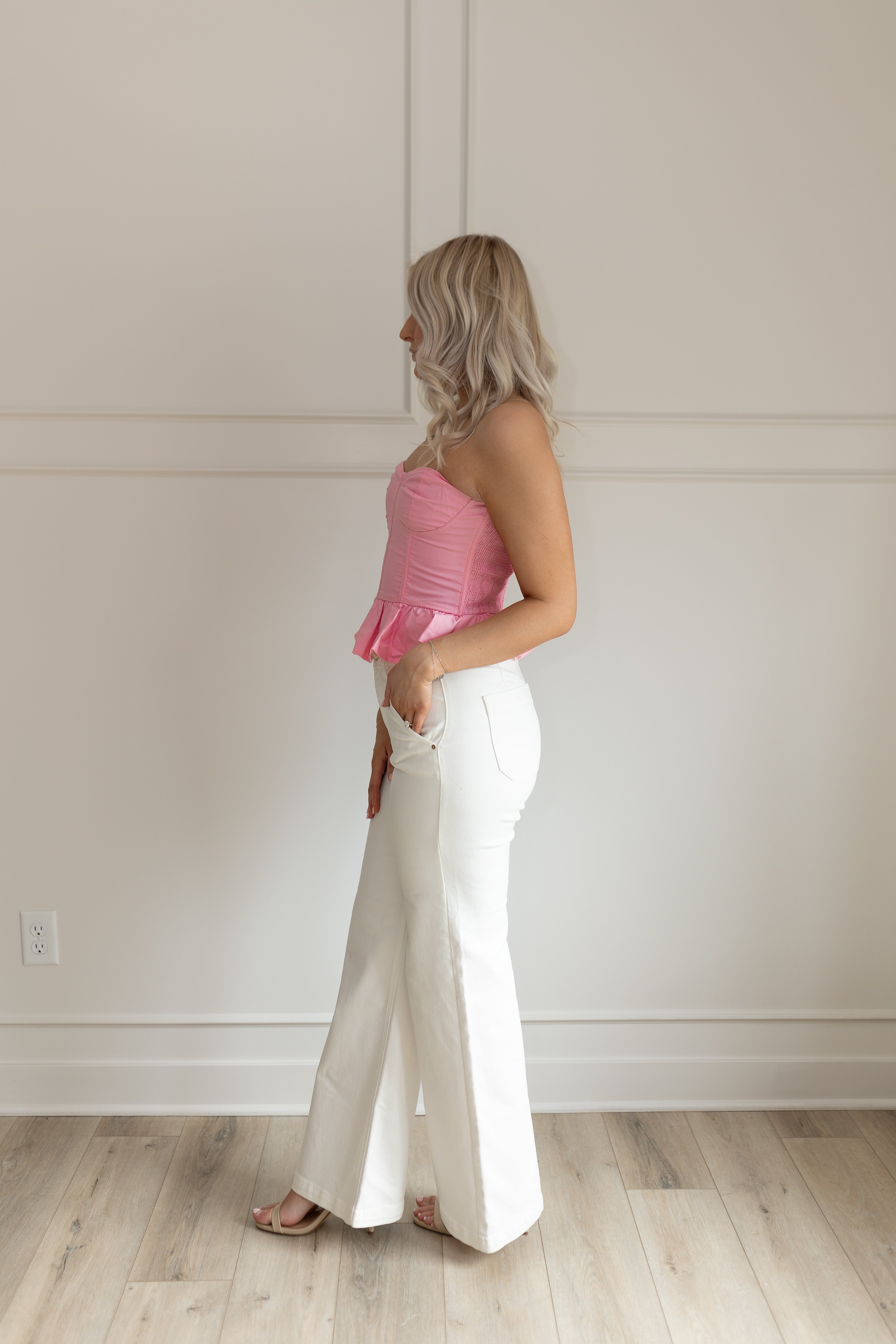 Pink strapless corset peplum top. Smocked back with hidden zipper.