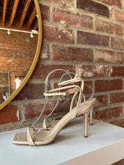 Nude stiletto sandal with square toe and nude ankle strap
