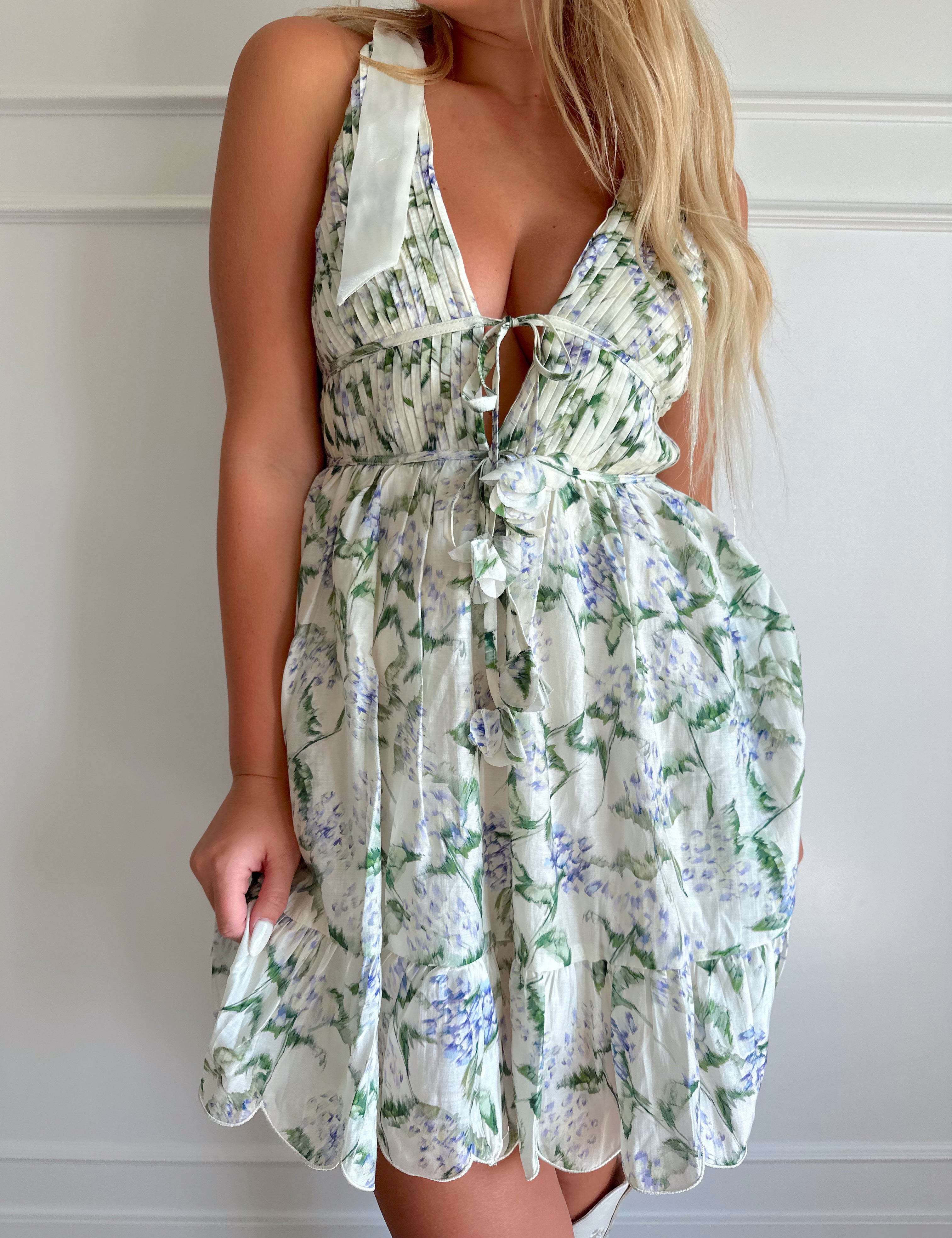 Cream mini dress with lilac and green floral pattern.