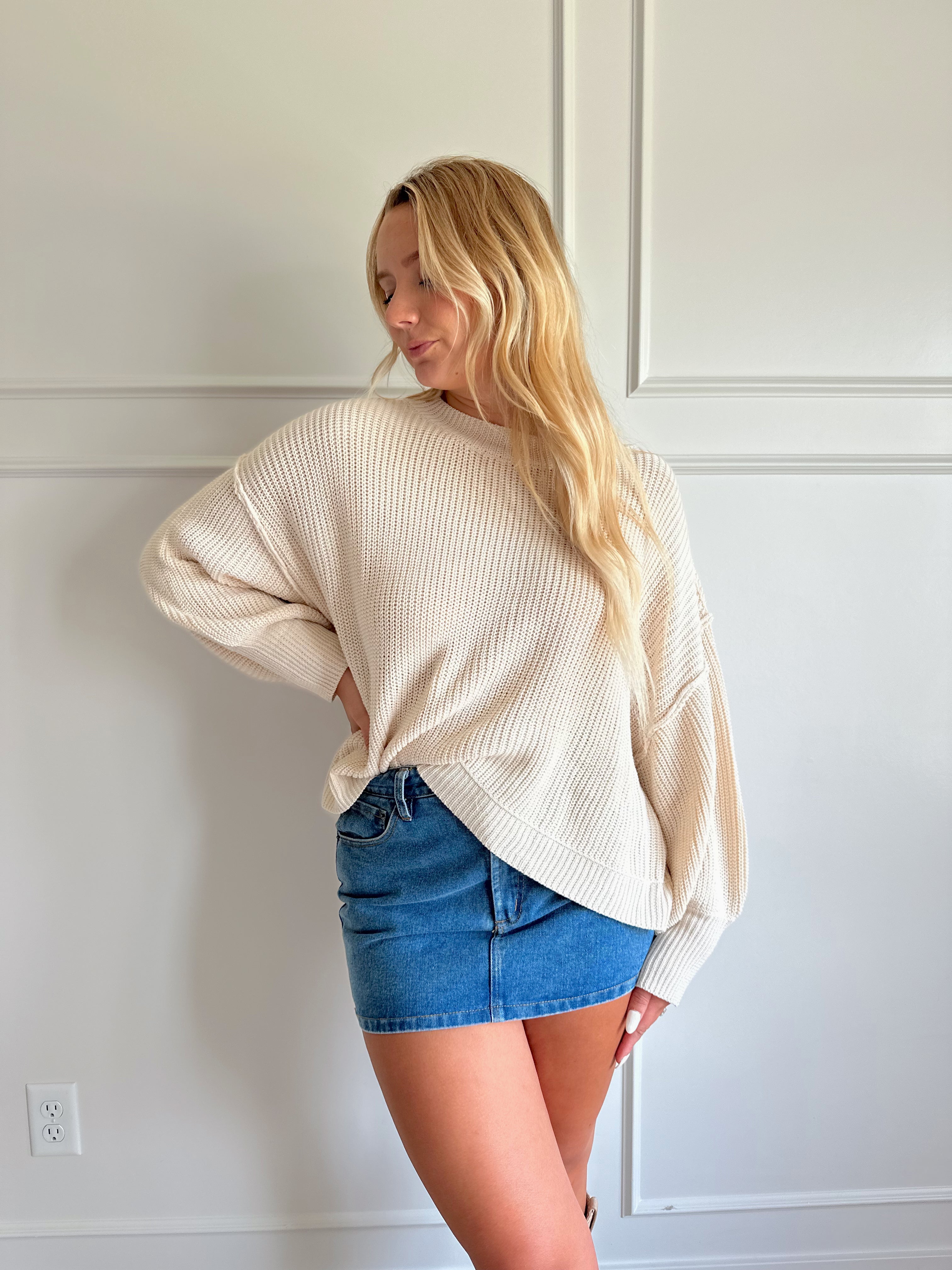 Medium wash denim mini skirt with functional pockets and belt loops.