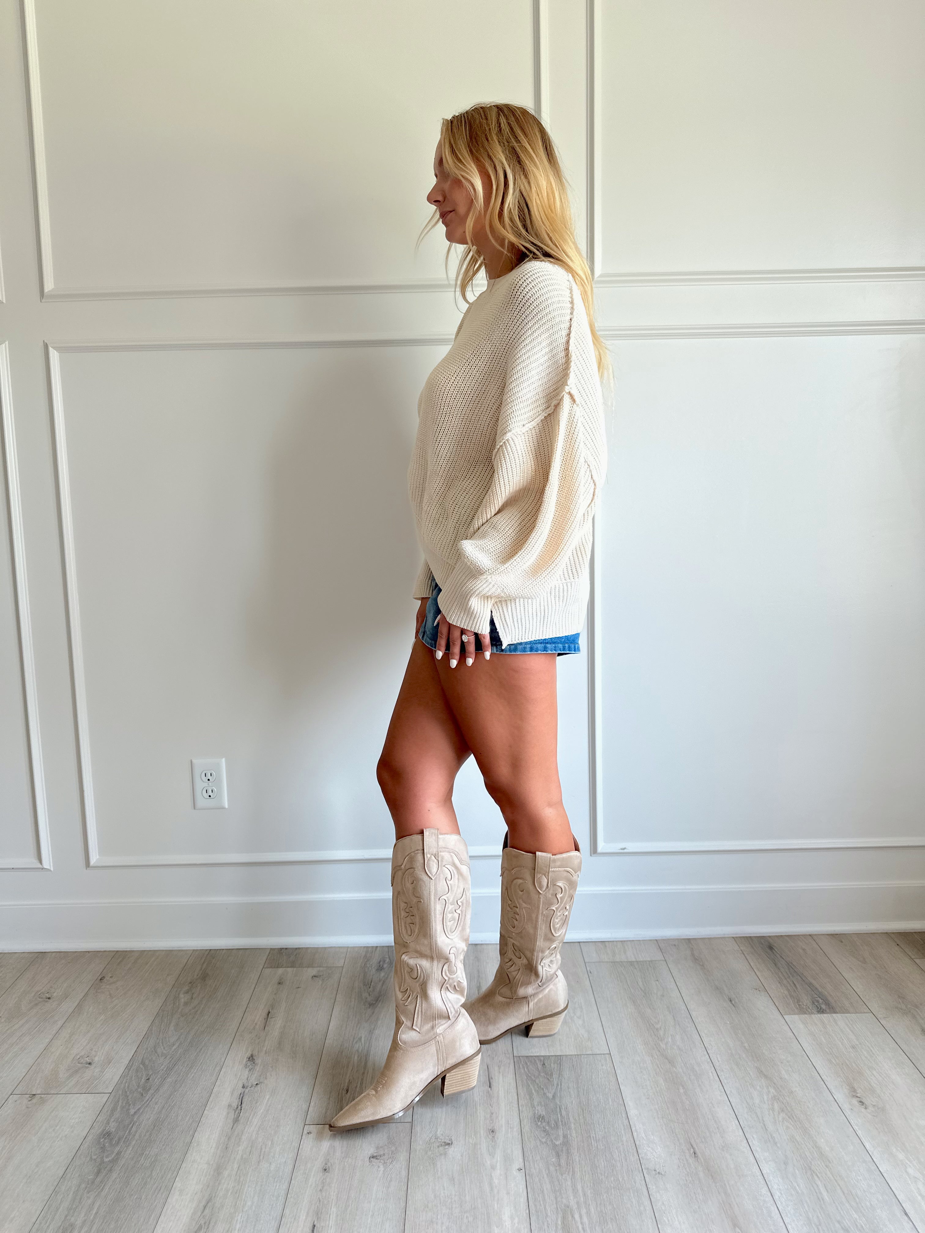 Medium wash denim mini skirt with functional pockets and belt loops.