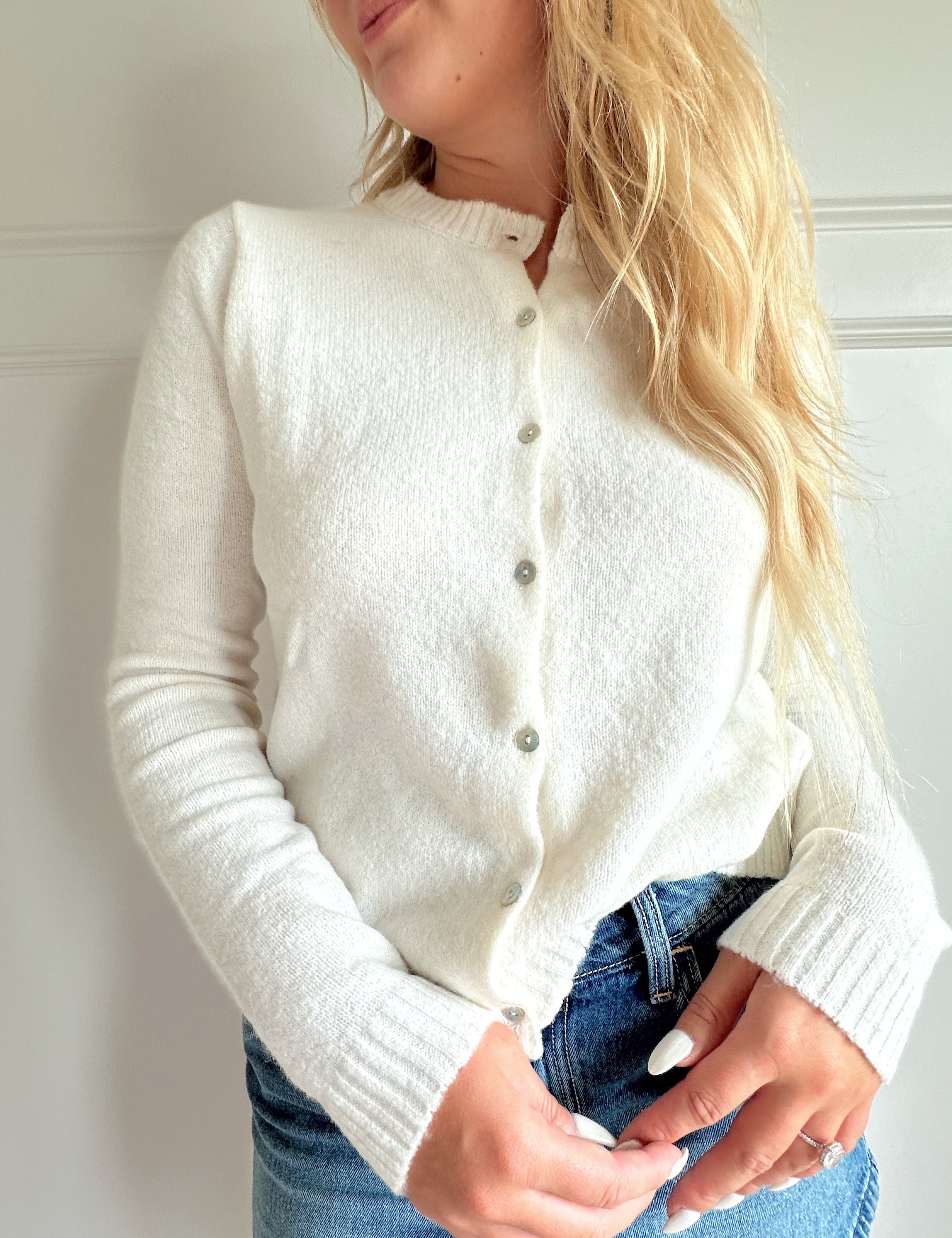 Off white knit cardigan with iridescent button detailing.