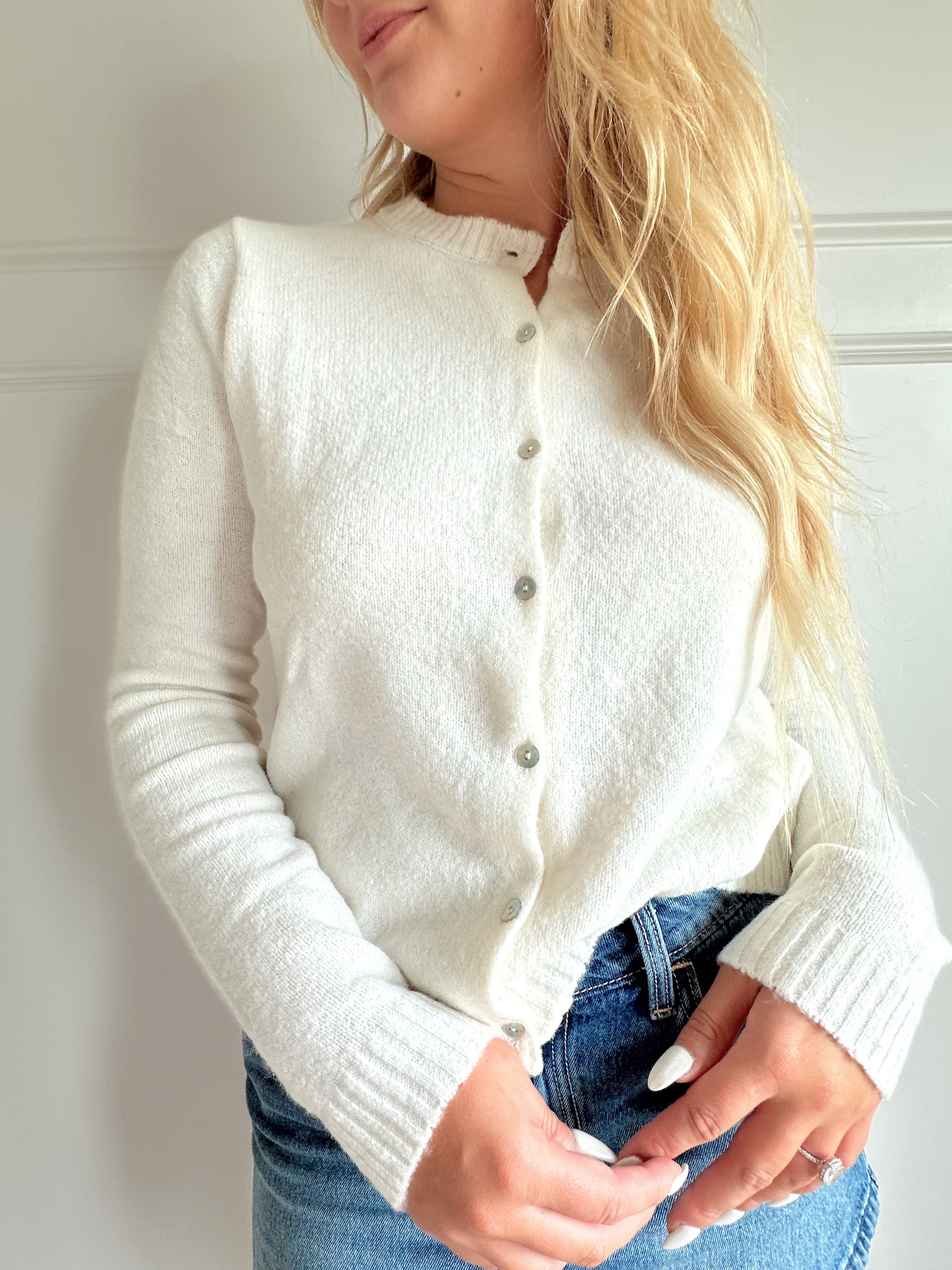 Off white knit cardigan with iridescent button detailing.