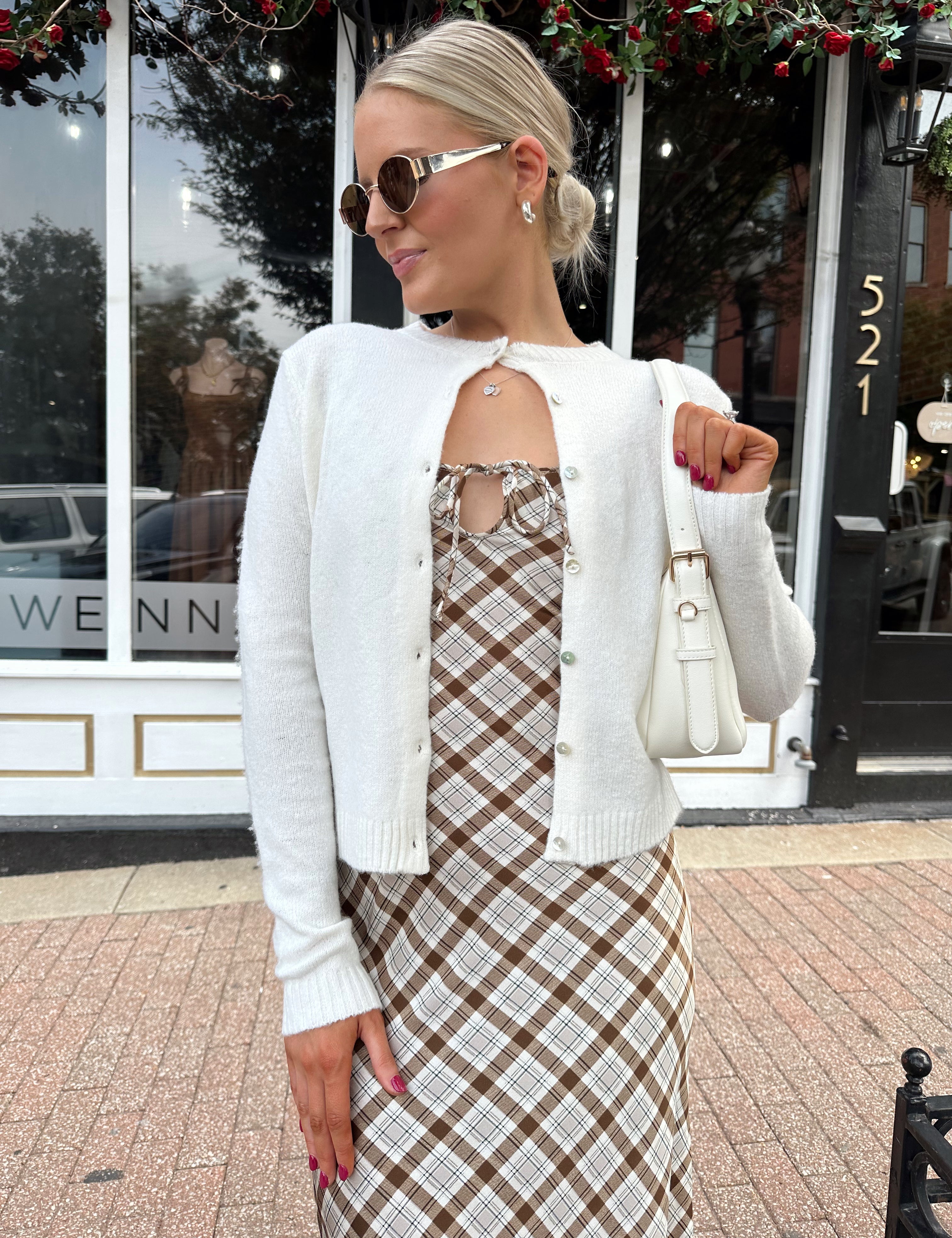 Off white knit cardigan with iridescent button detailing.