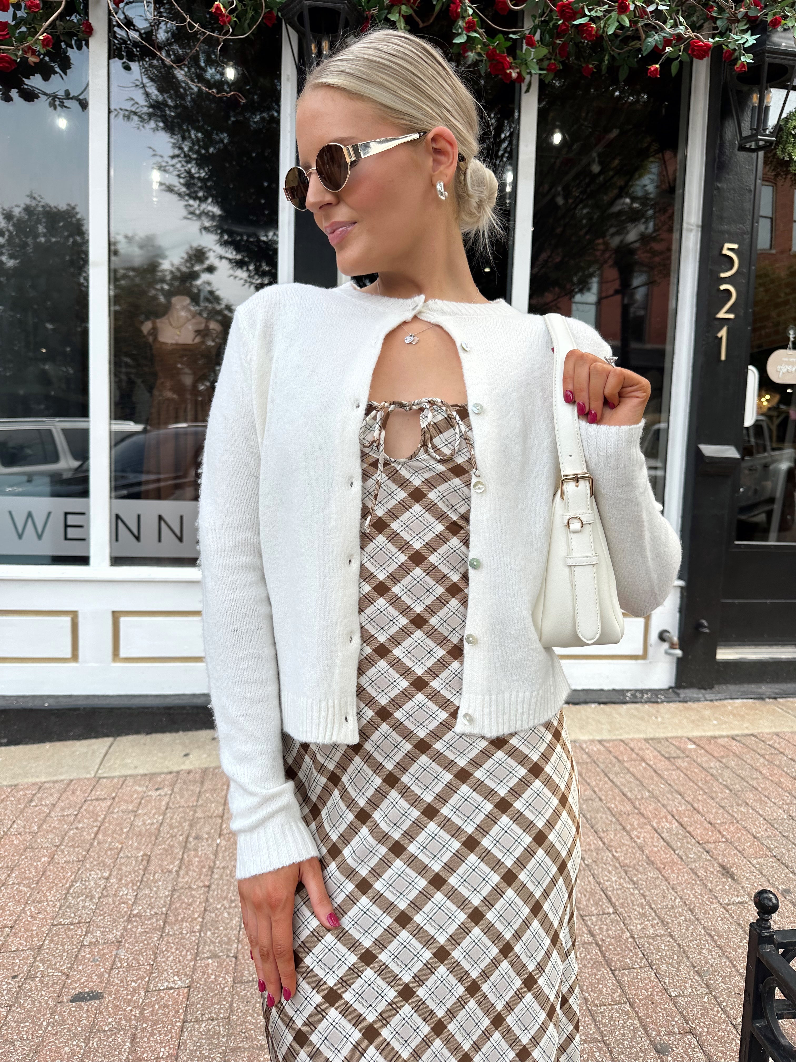 Off white knit cardigan with iridescent button detailing.