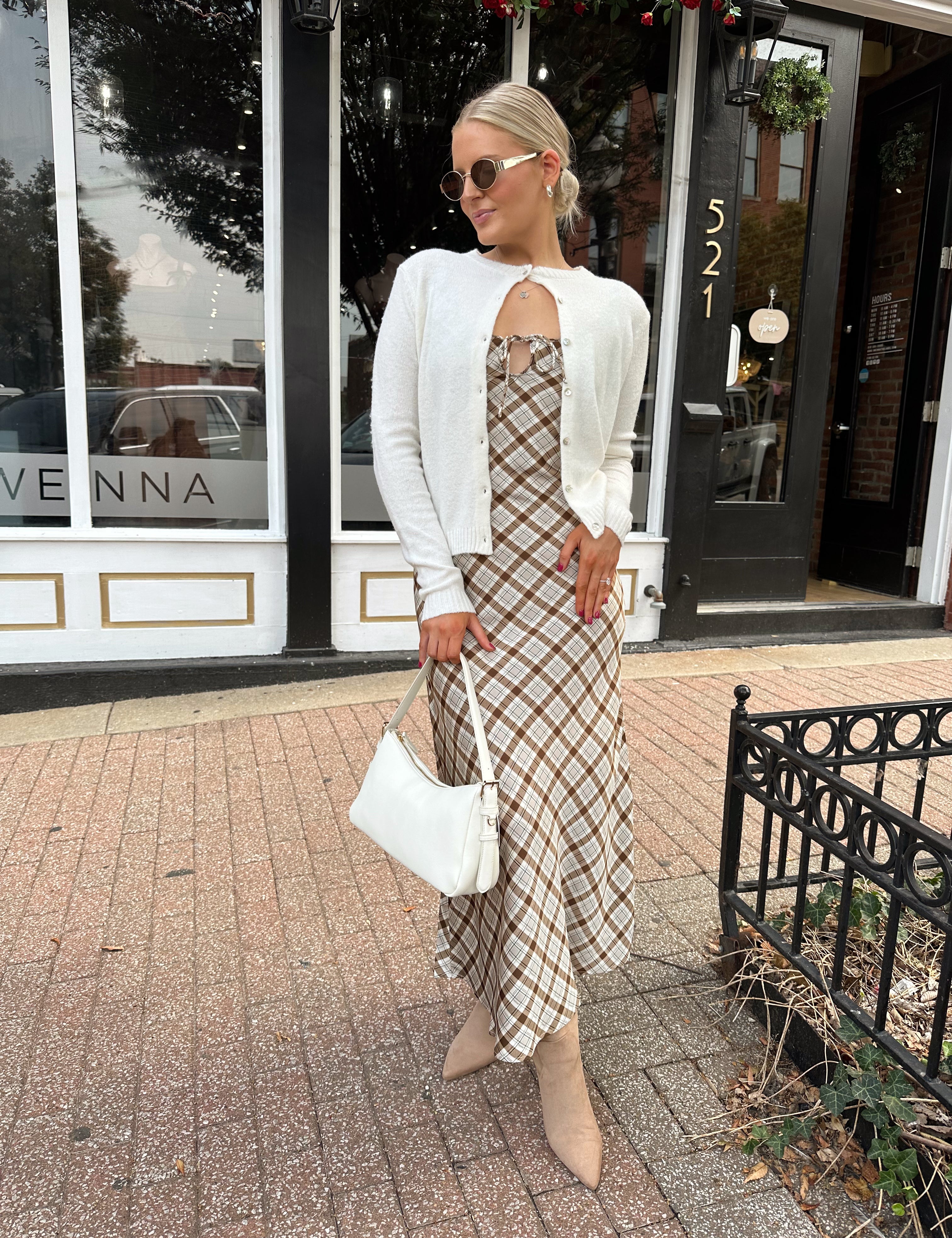Off white knit cardigan with iridescent button detailing.