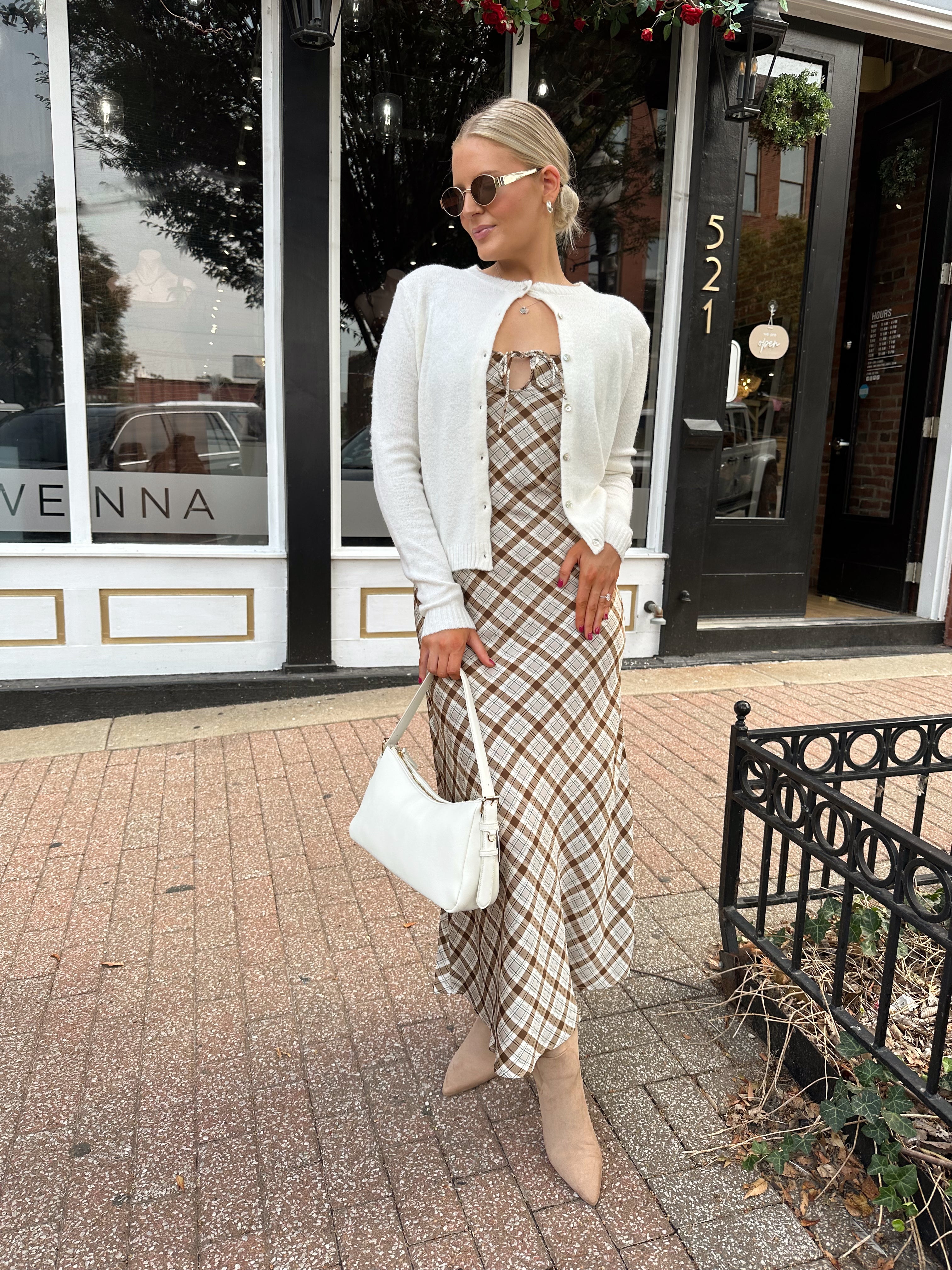 Off white knit cardigan with iridescent button detailing.