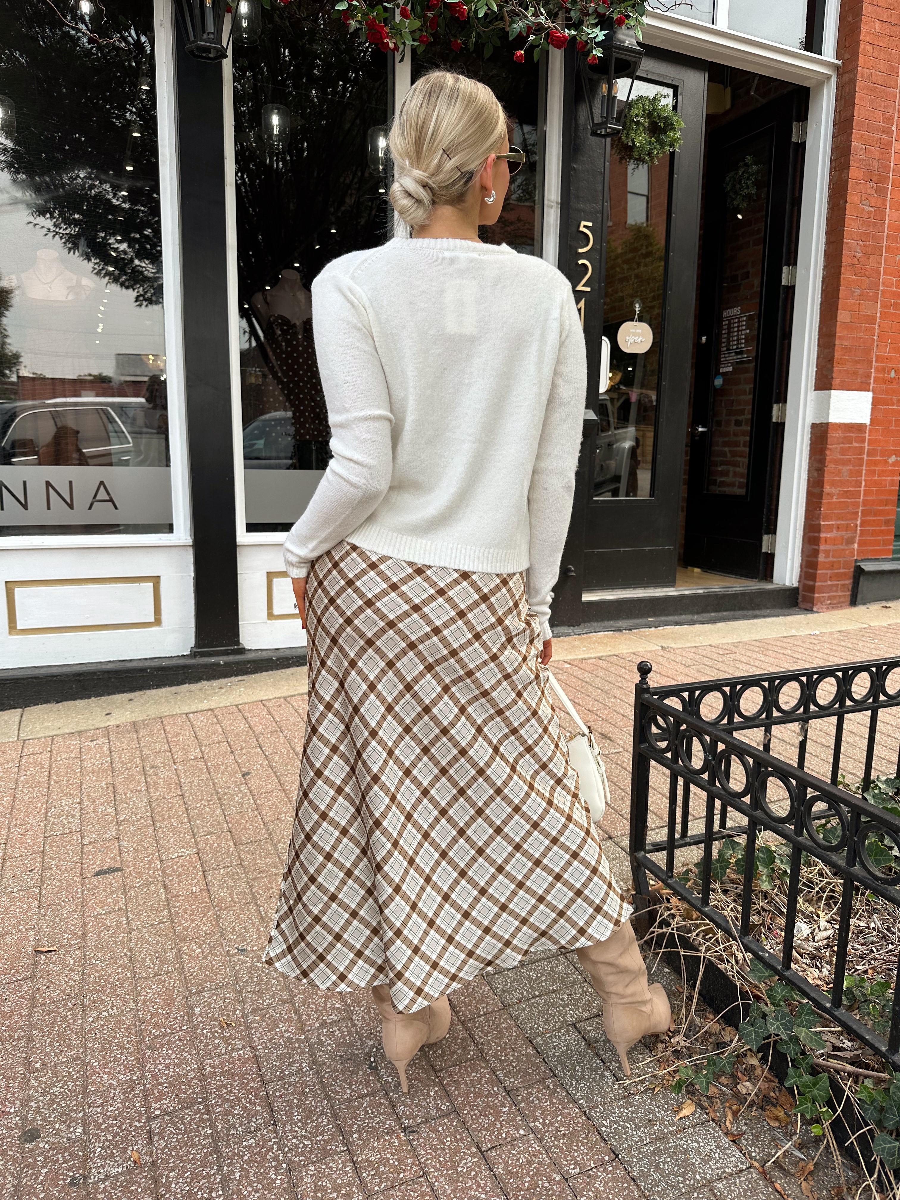 Off white knit cardigan with iridescent button detailing.