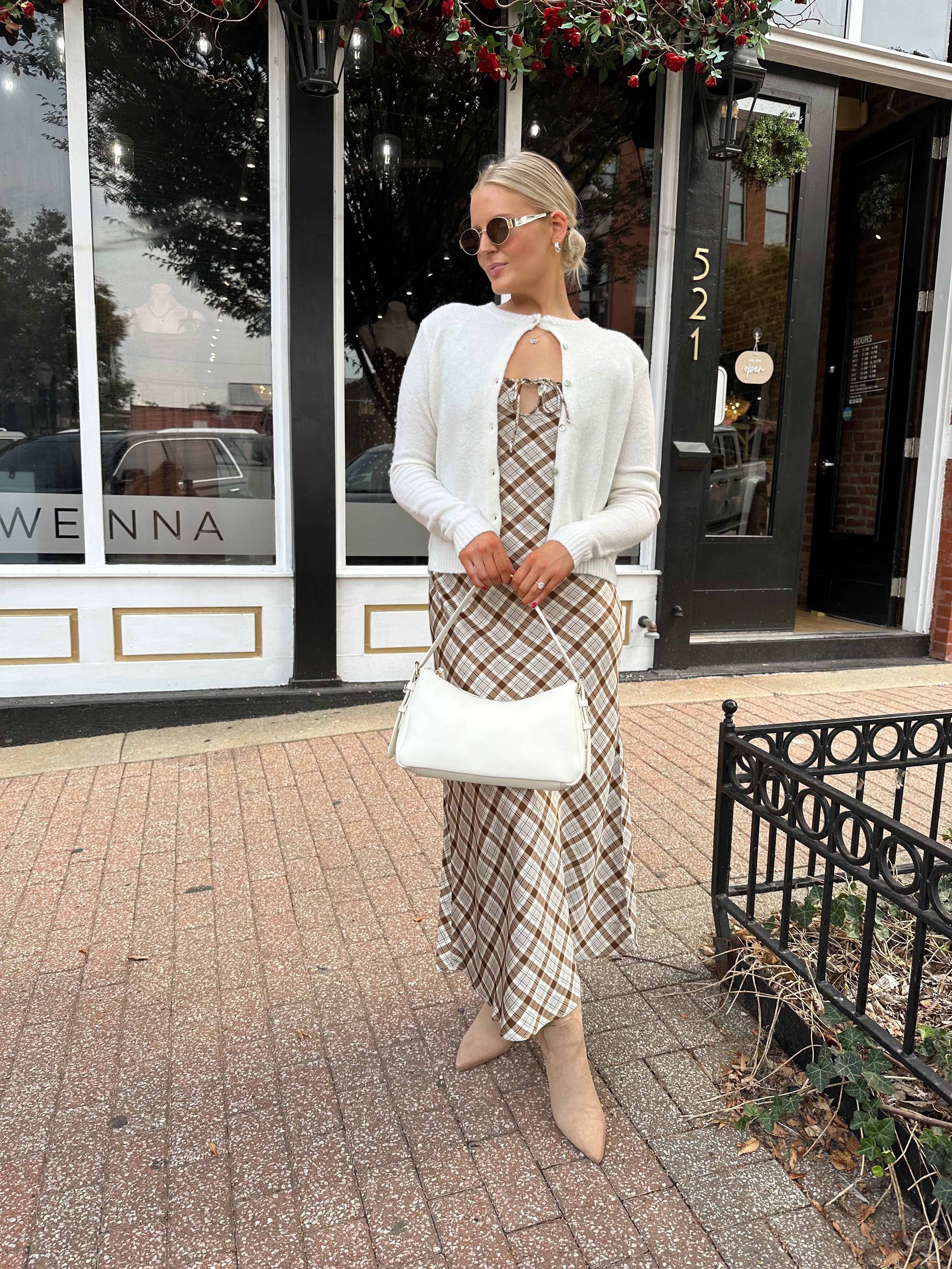 Off white knit cardigan with iridescent button detailing.
