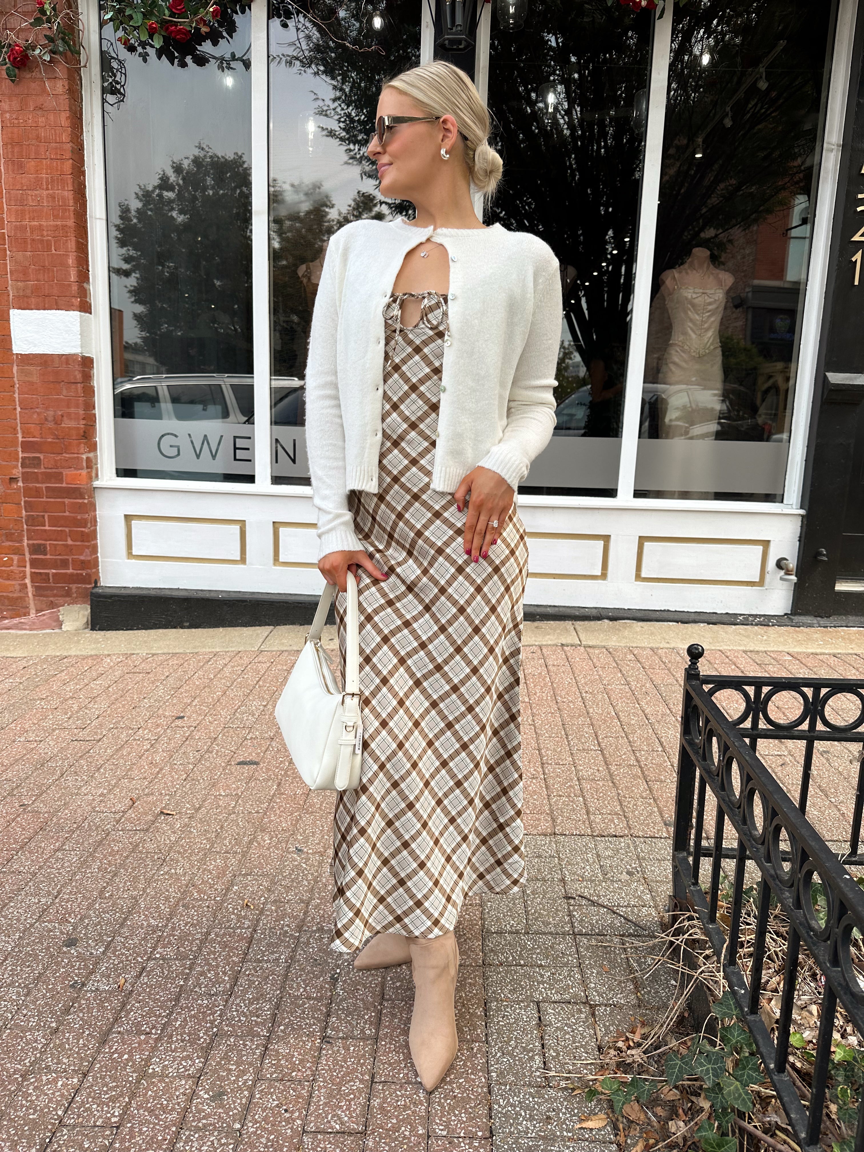 Off white knit cardigan with iridescent button detailing.