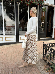 Off white knit cardigan with iridescent button detailing.