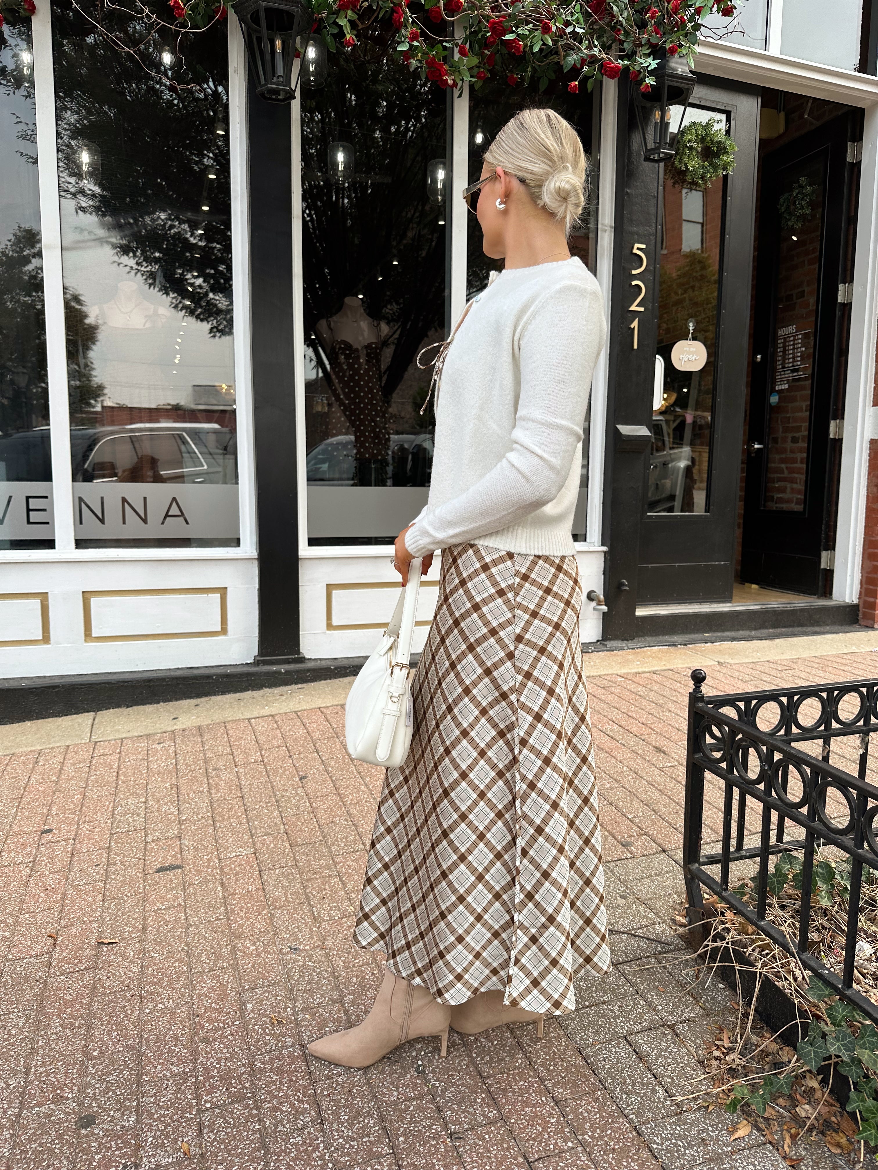 Off white knit cardigan with iridescent button detailing.