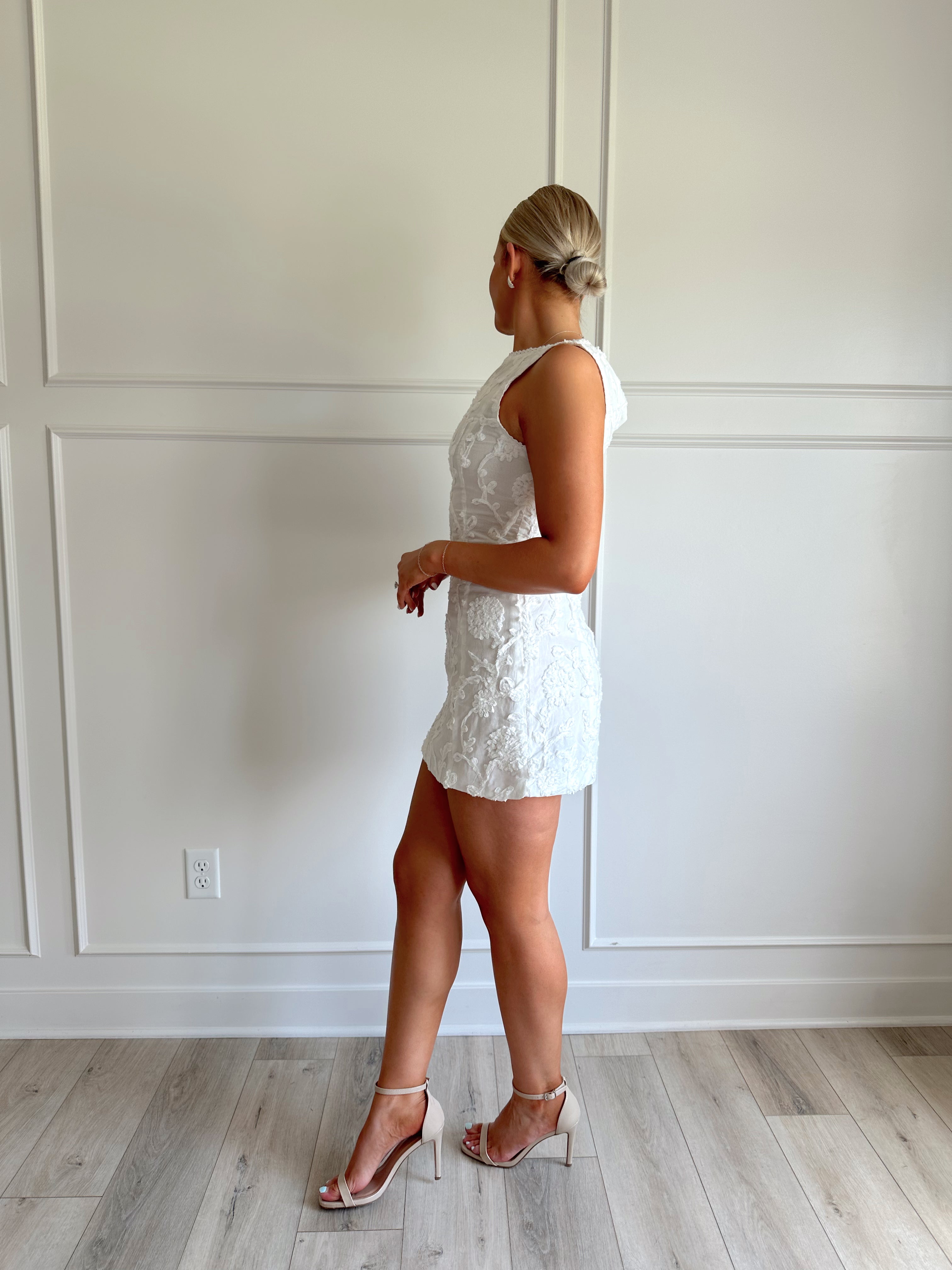 White a-line mini dress with floral jacquard pattern.