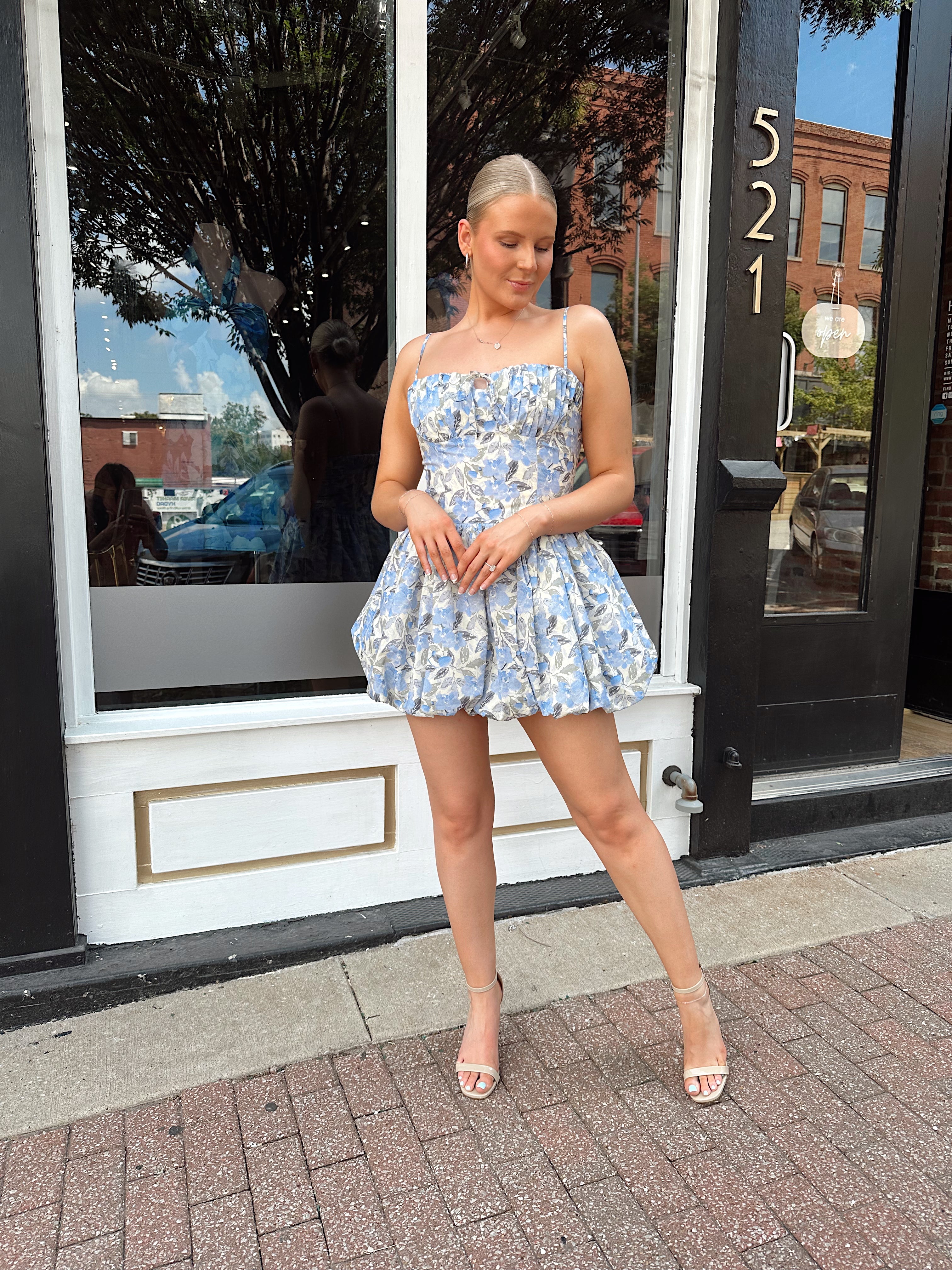 Blue floral bustier mini dress with bubble hem and tie detail.