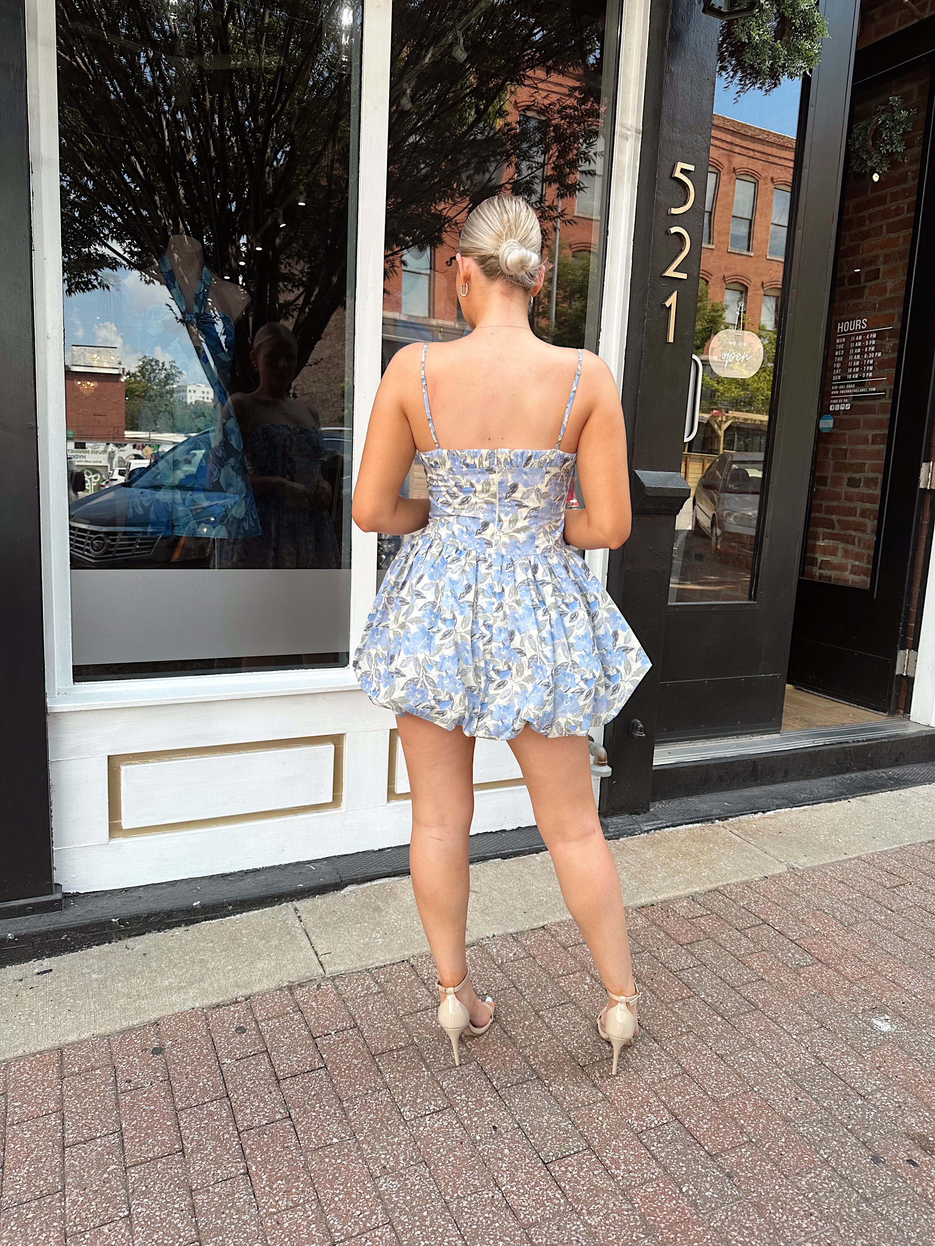 Blue floral bustier mini dress with bubble hem and tie detail.