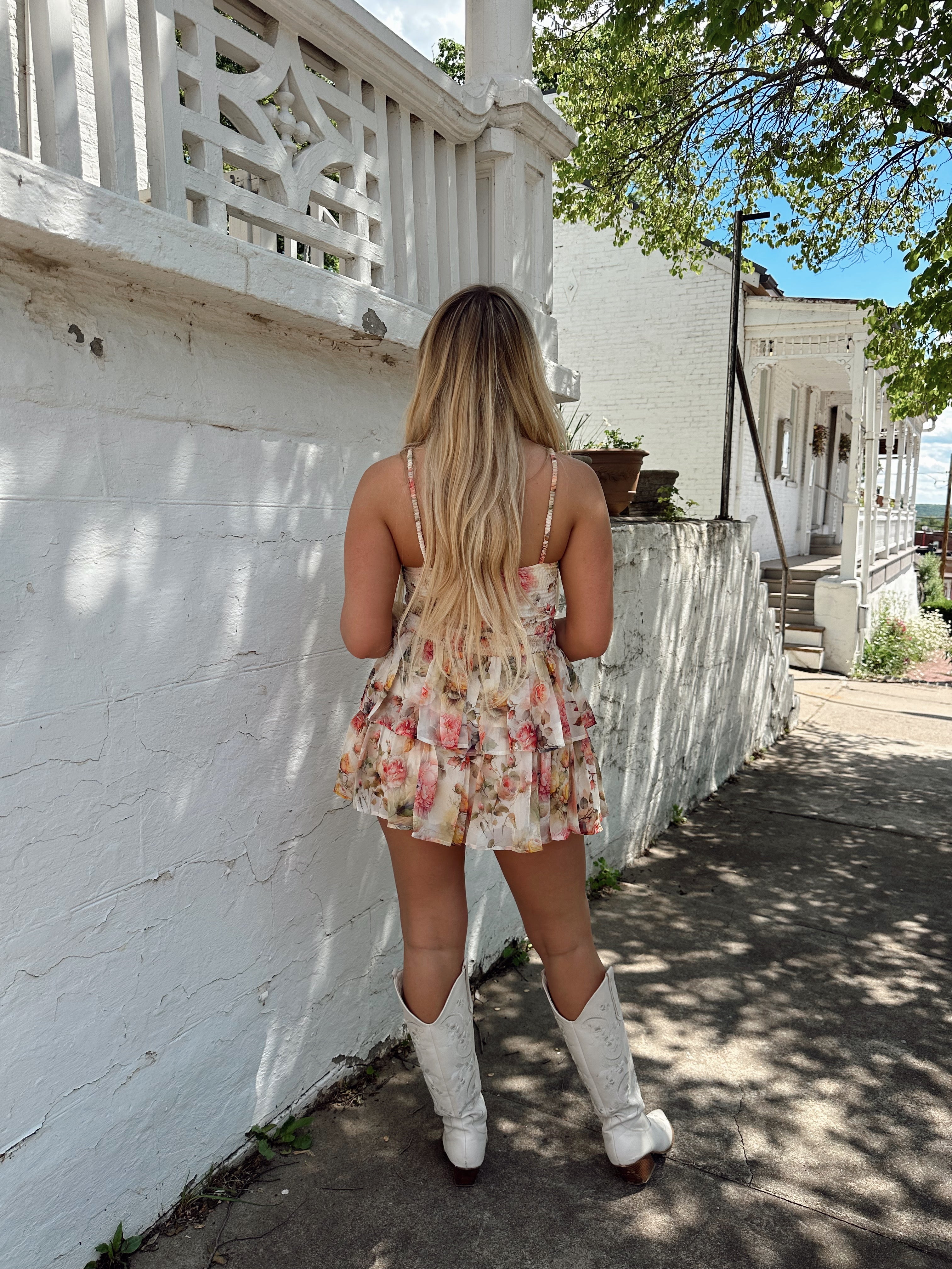 Ivory tiered mini dress with multicolor floral pattern and adjustable spaghetti straps