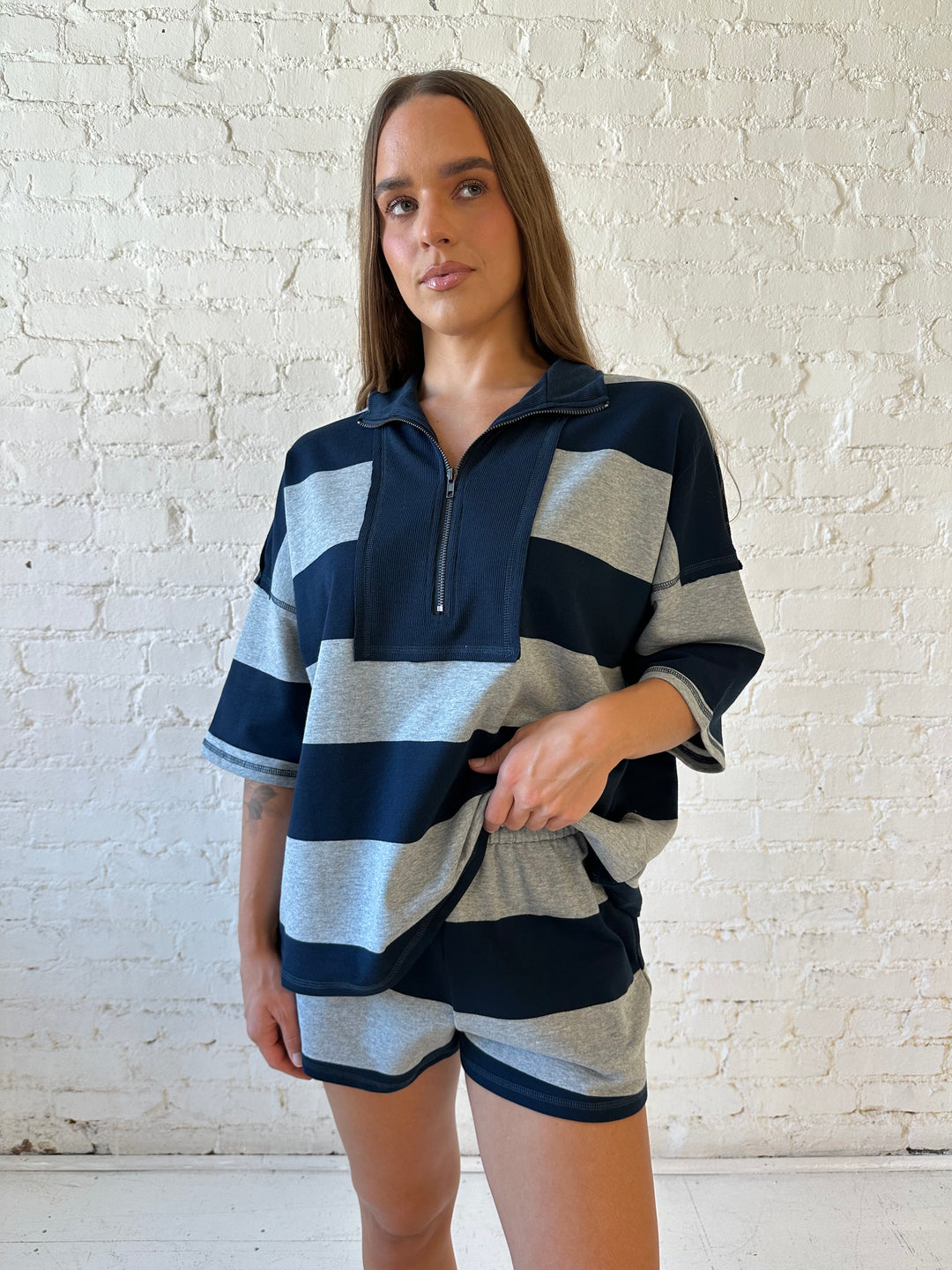 Woman wearing navy and grey chunky striped two piece lounge set with relaxed boxy fit.