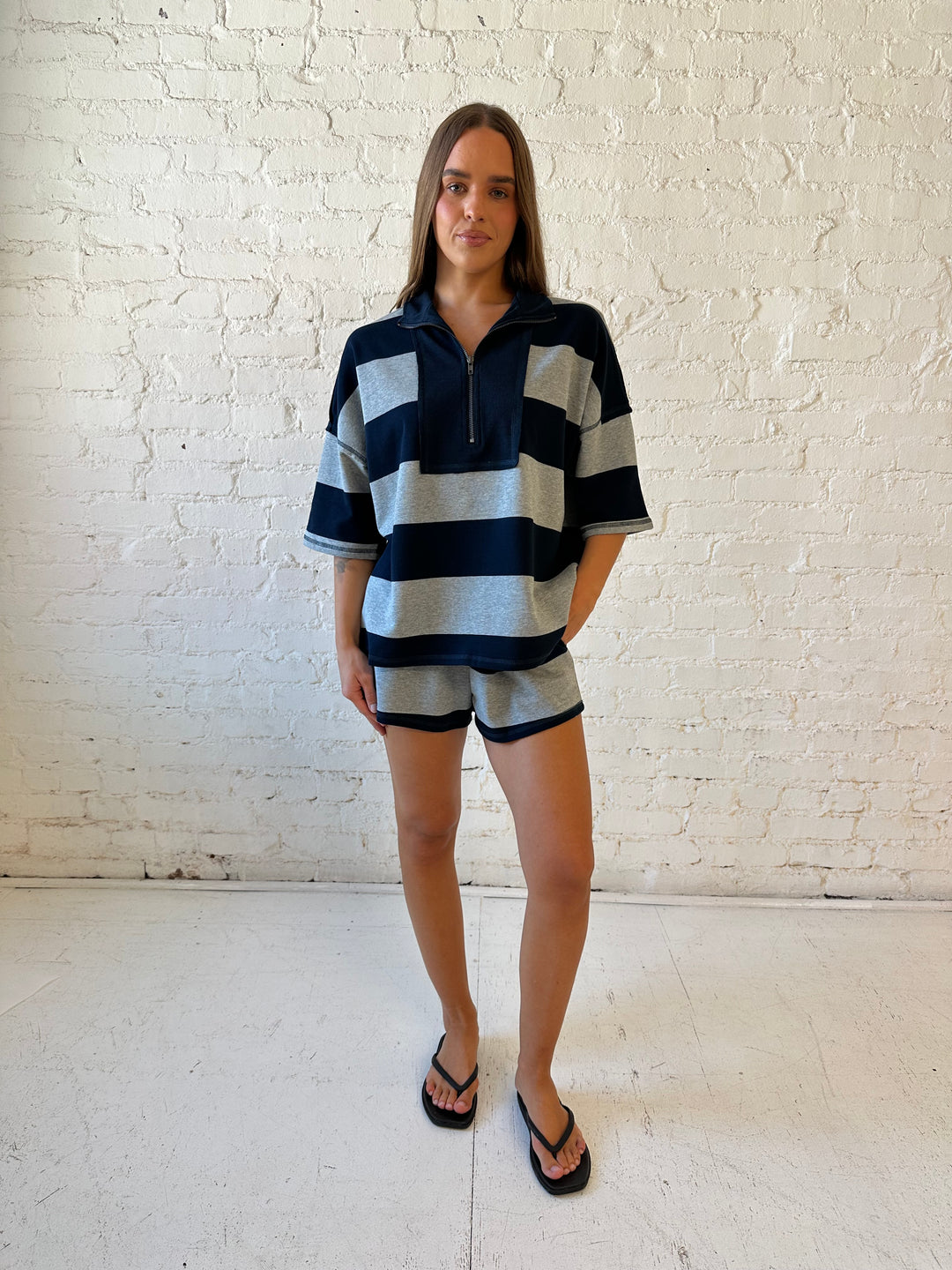 Woman wearing navy and grey chunky striped two piece lounge set with relaxed boxy fit.