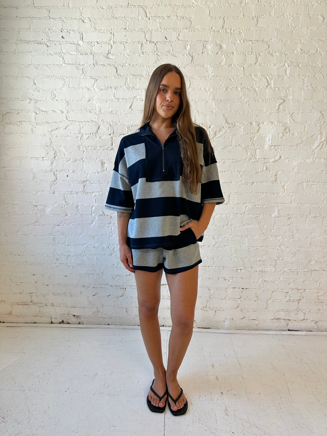 Woman wearing navy and grey chunky striped two piece lounge set with relaxed boxy fit.