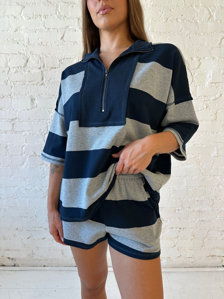 Woman wearing navy and grey chunky striped two piece lounge set with relaxed boxy fit.
