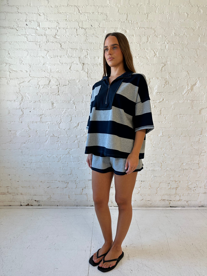 Woman wearing navy and grey chunky striped two piece lounge set with relaxed boxy fit.