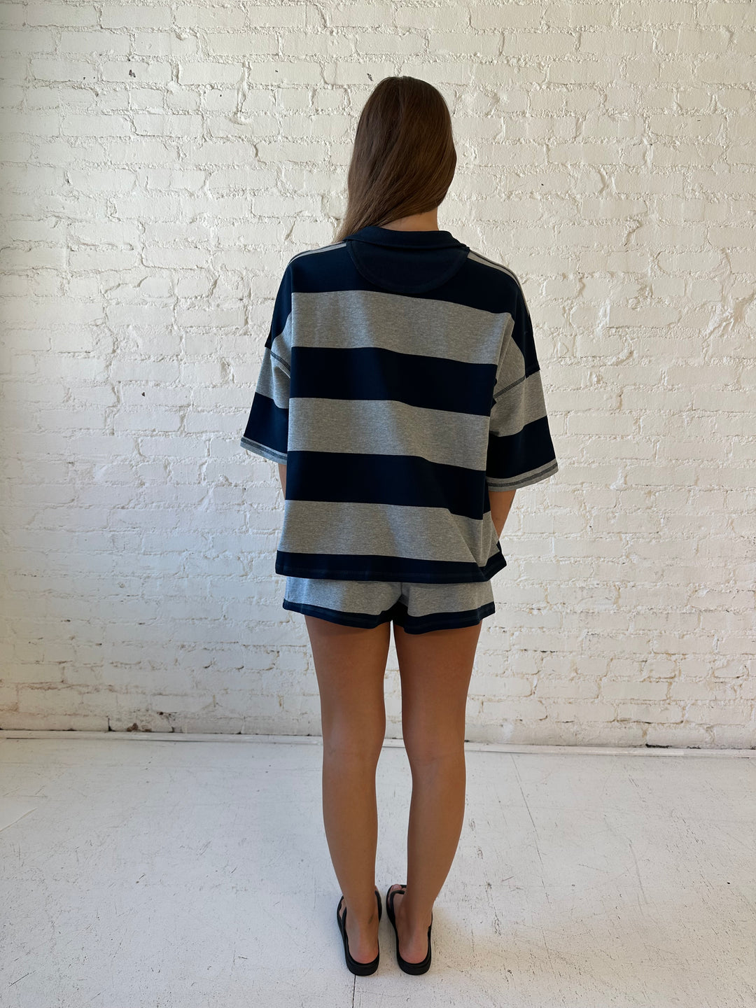 Woman wearing navy and grey chunky striped two piece lounge set with relaxed boxy fit.