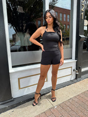 Woman wearing black tailored shorts. 
