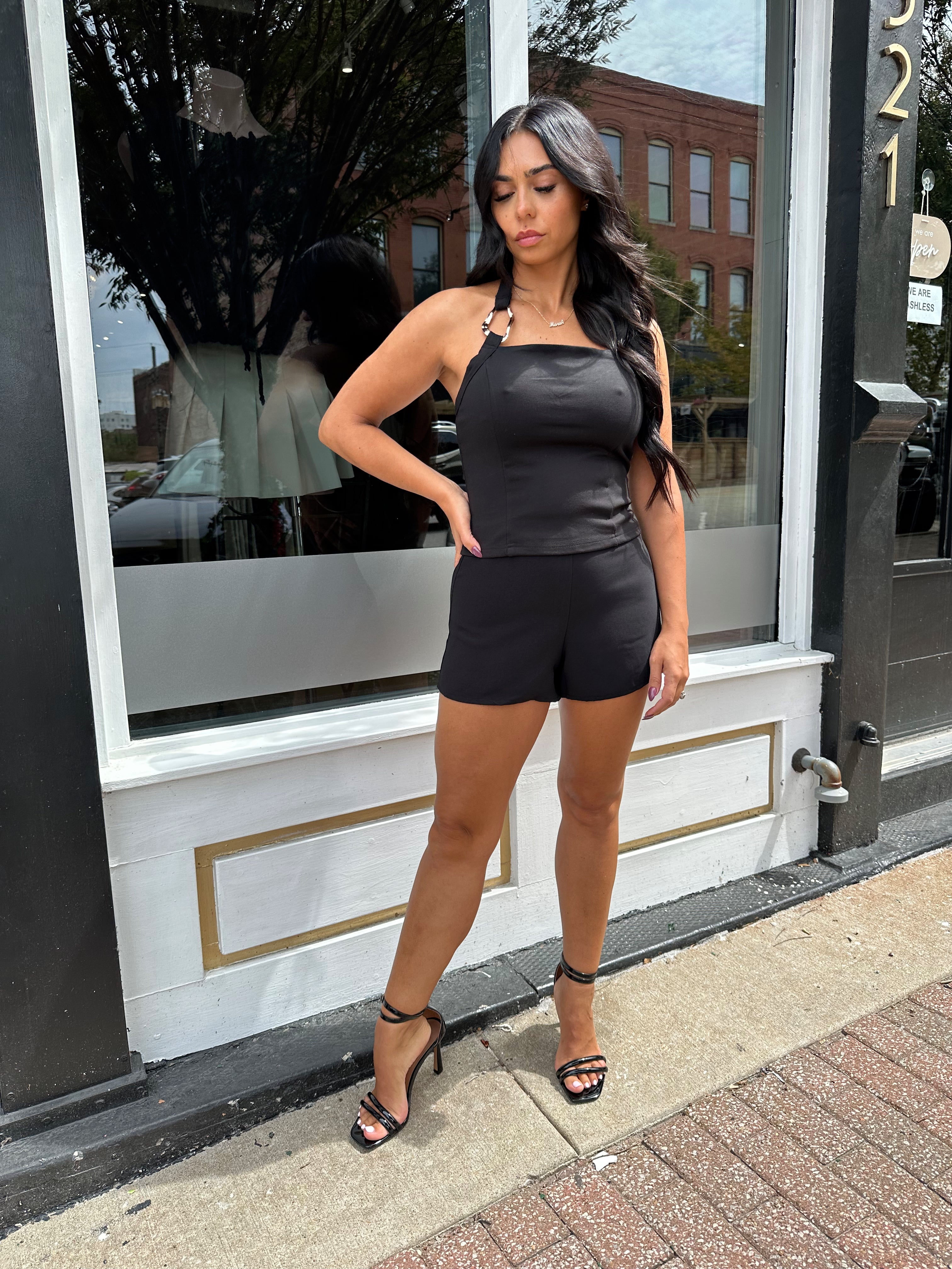 Woman wearing black tailored shorts. 