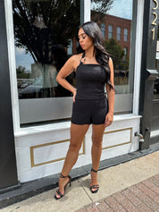 Woman wearing black tailored shorts. 