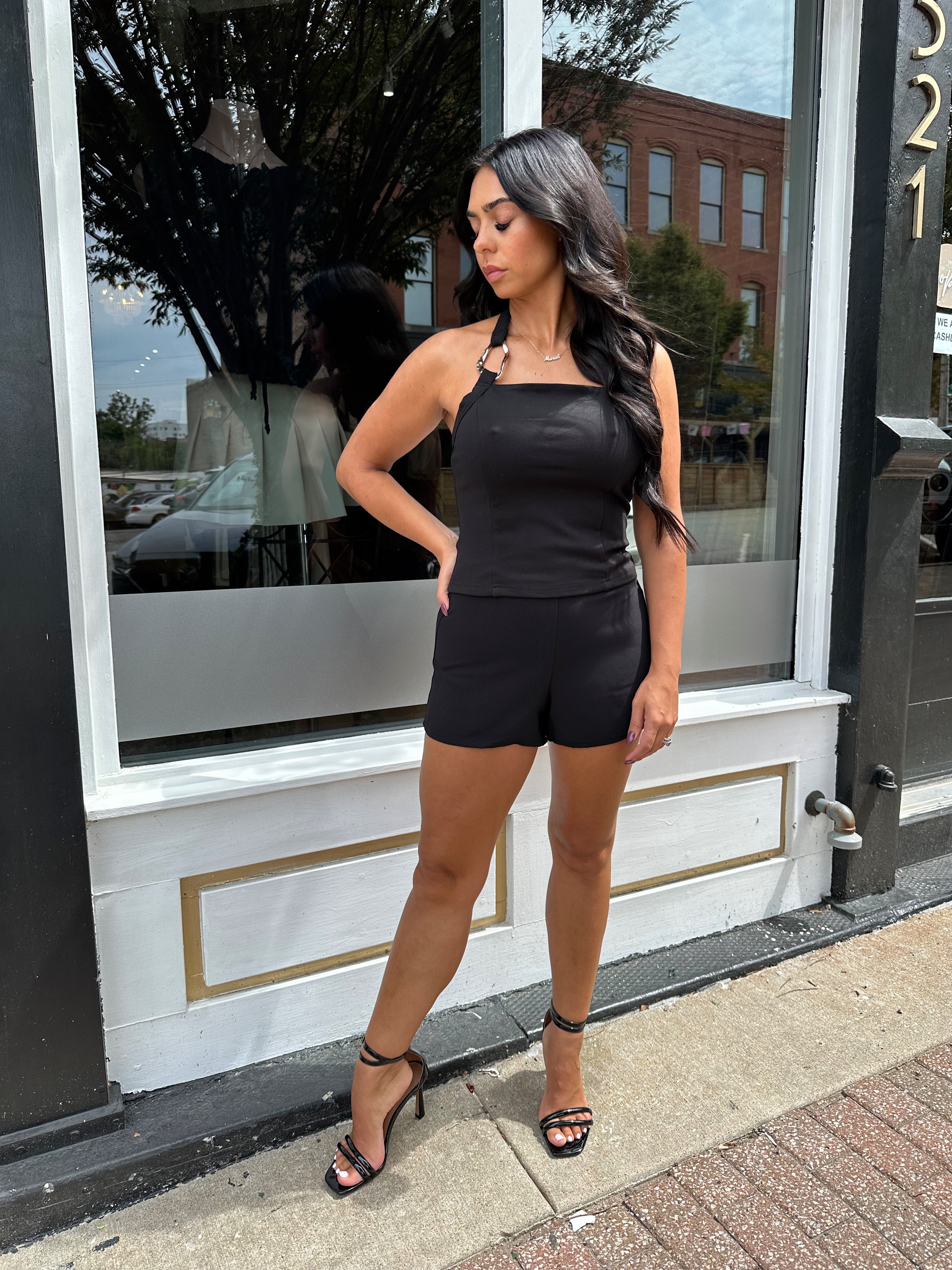 Woman wearing black tailored shorts. 