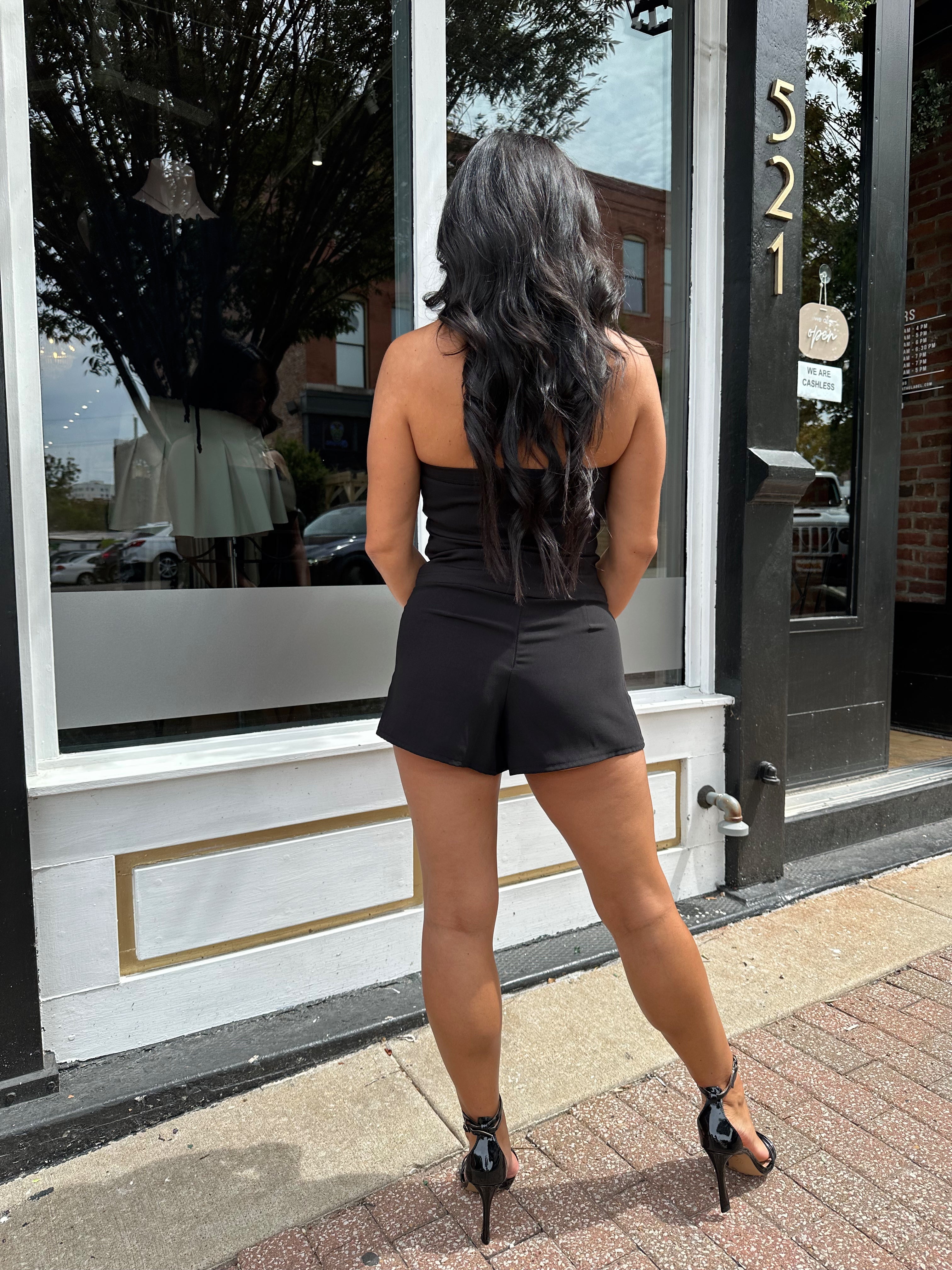 Woman wearing black tailored shorts. 