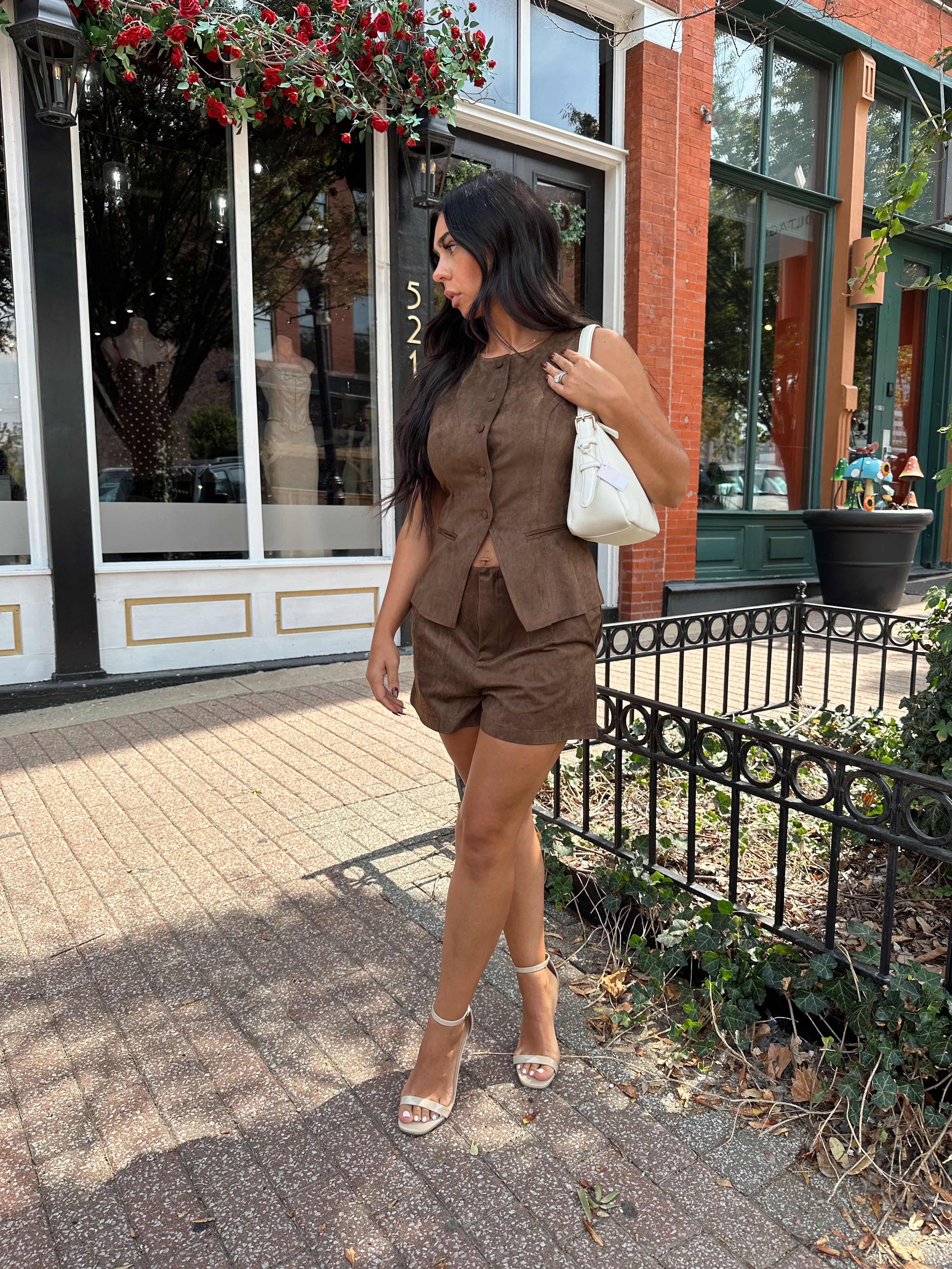 Woman wearing espresso brown suede short with matching vest top.